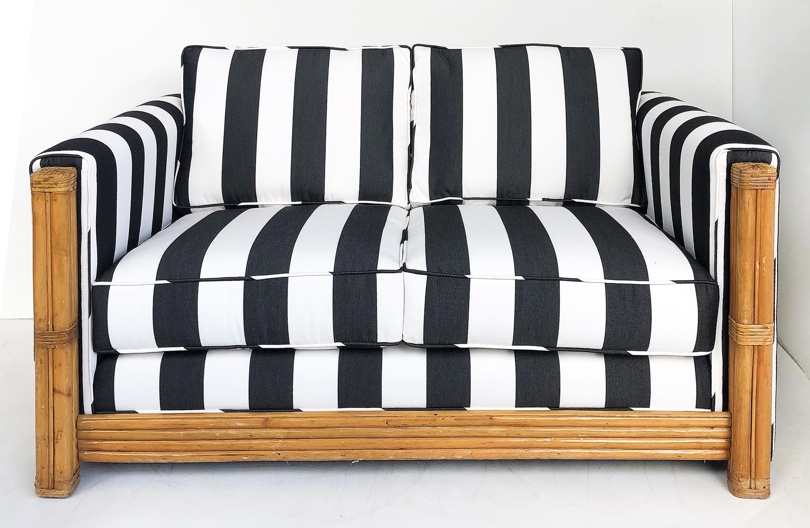 Rattan loveseat newly upholstered with black & white striped fabric

Offered for sale is a rattan loveseat newly upholstered with black and white striped fabric. The frame is rattan with wrapped ends. there is some vintage wear to the legs as
