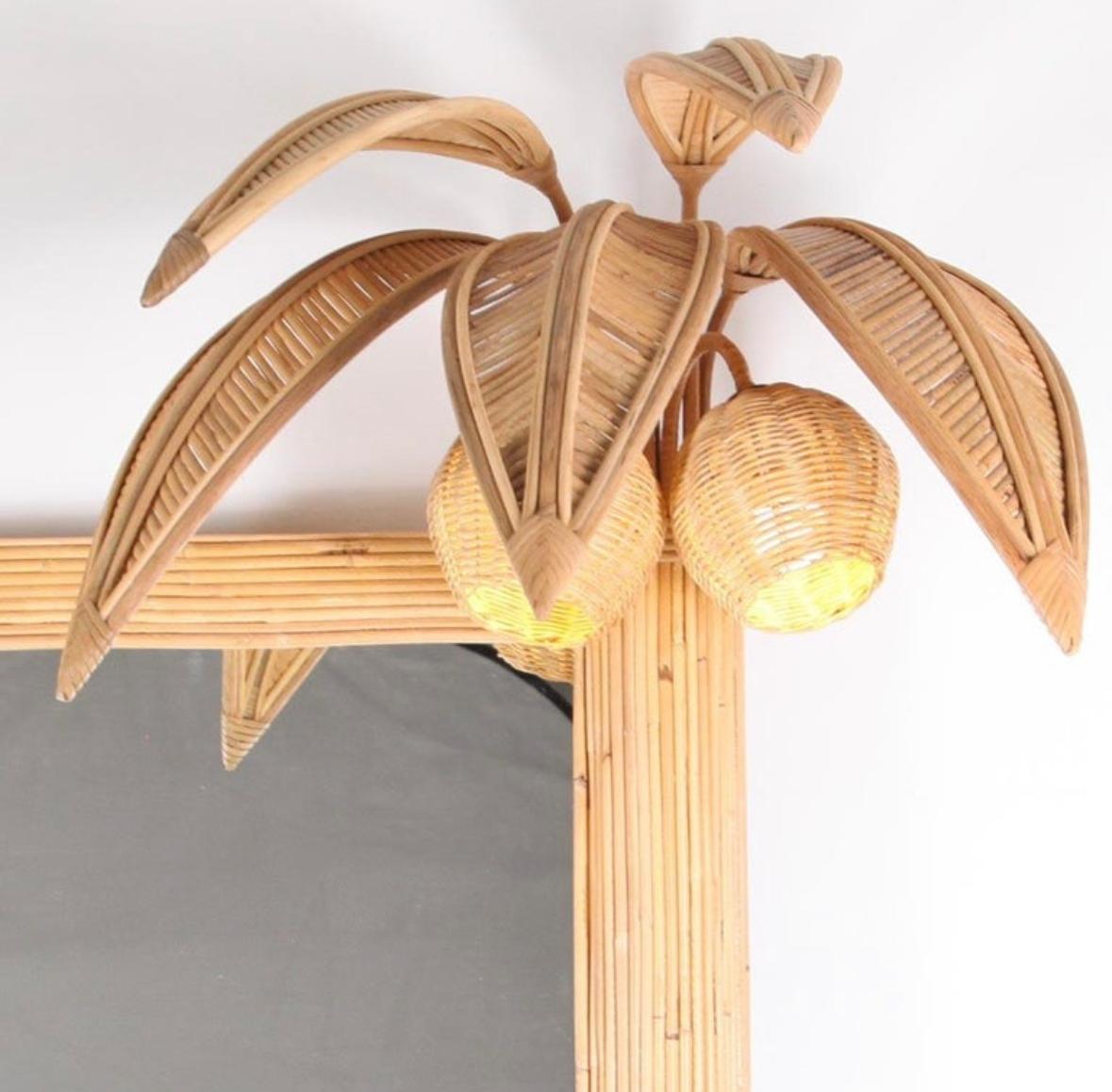 Très joli rotin  miroir mural avec 4 lumières dans les noix de coco. 
Design/One unique, typique des années soixante-dix. Travail de haute qualité entièrement réalisé à la main. Excellent état.