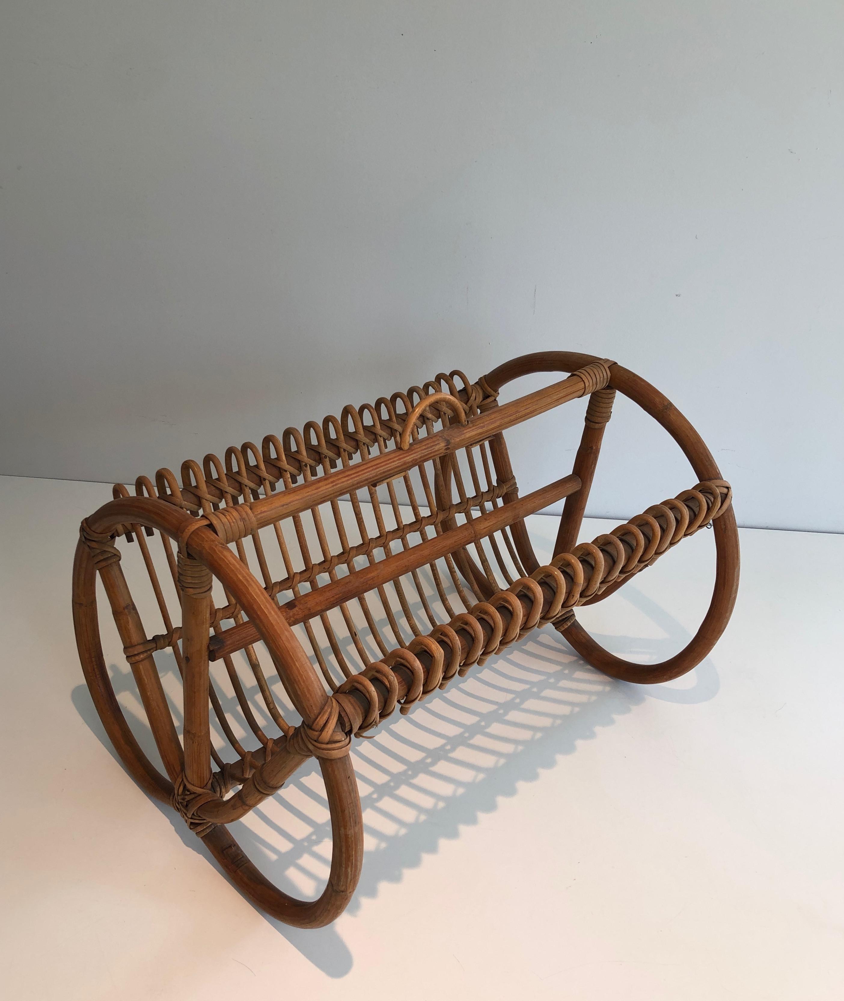 This very nice and unusual magazine rack is made of rattan. This is a French work, circa 1950.