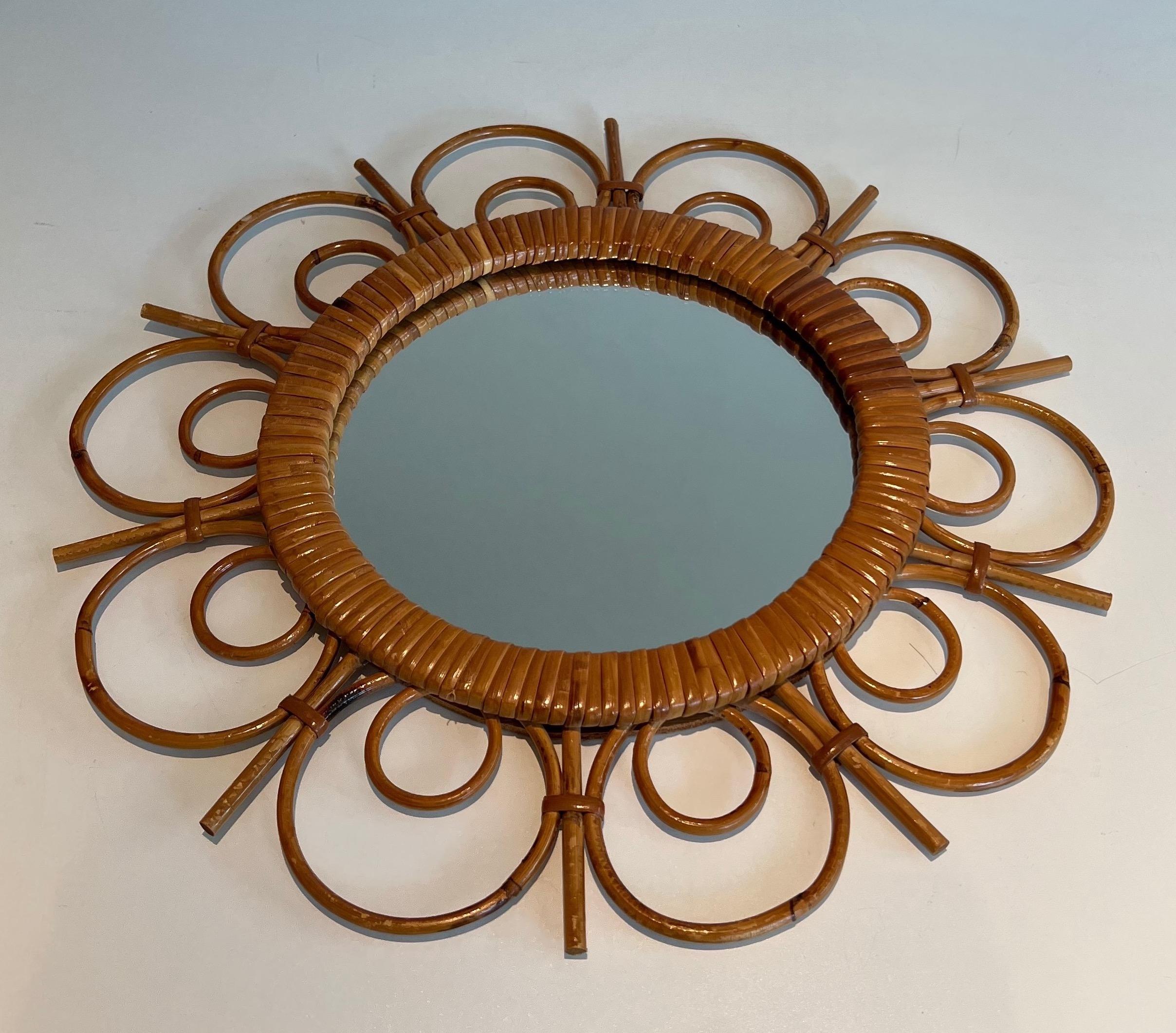 This nice and unusual mirror is made of rattan. This is a French work. Circa 1970