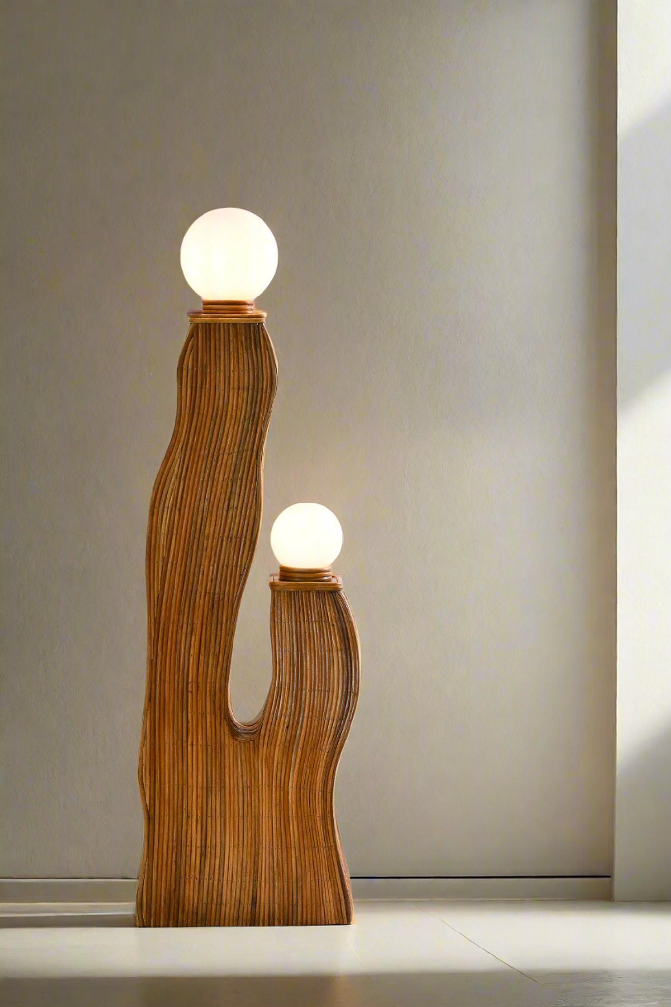 Elevate your decor with this mid-century style organic rattan sculptured floor lamp. Its sleek lines and geometric form pay homage to classic design while showcasing the natural beauty of rattan. The intricate weaving allows light to filter through,