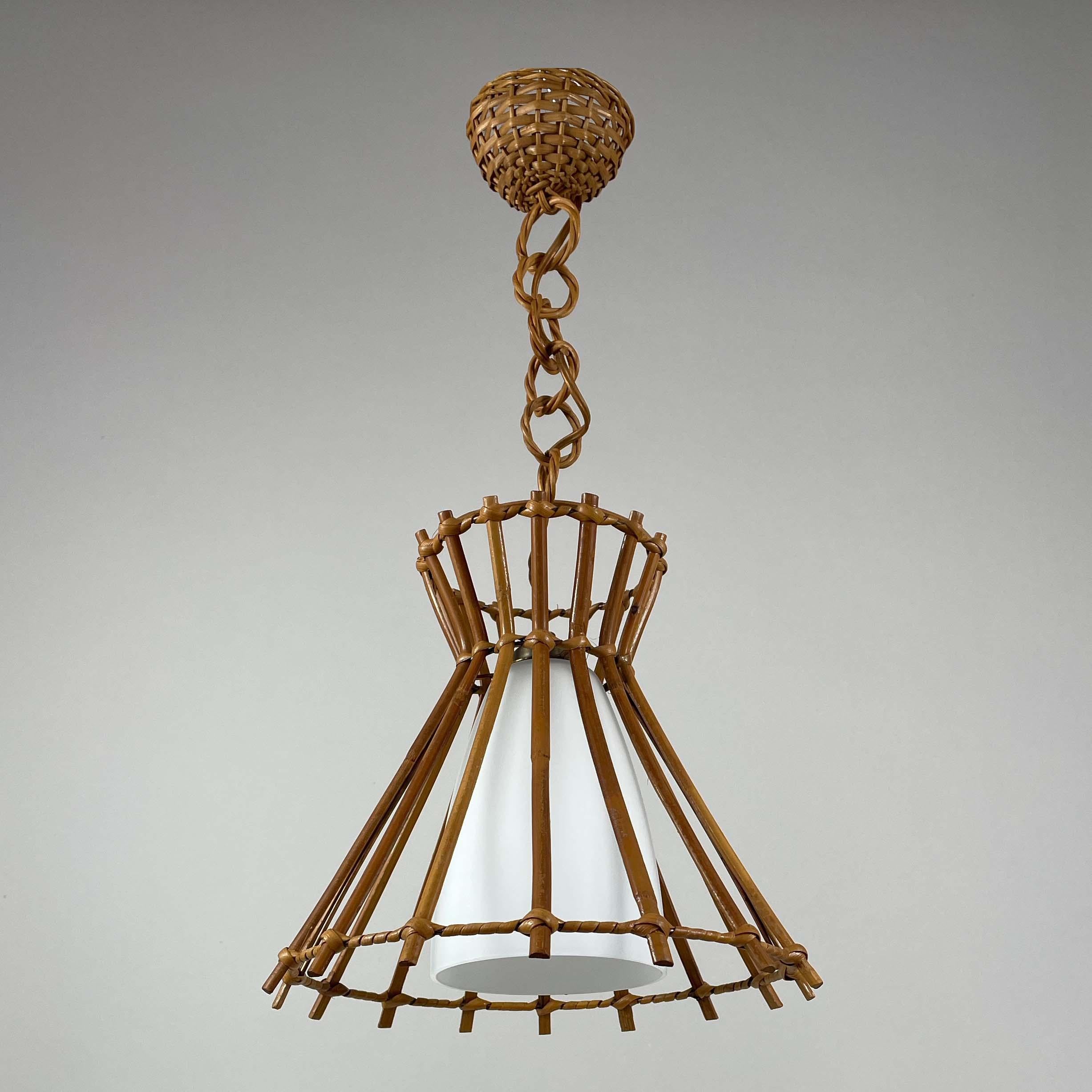 This elegant Riviera Style pendant or lantern was designed and manufactured in France in the late 1950s. It is rather similar to lights designed by Louis Sognot.

The pendant features a rattan body, rattan drop and rattan canopy. The inside