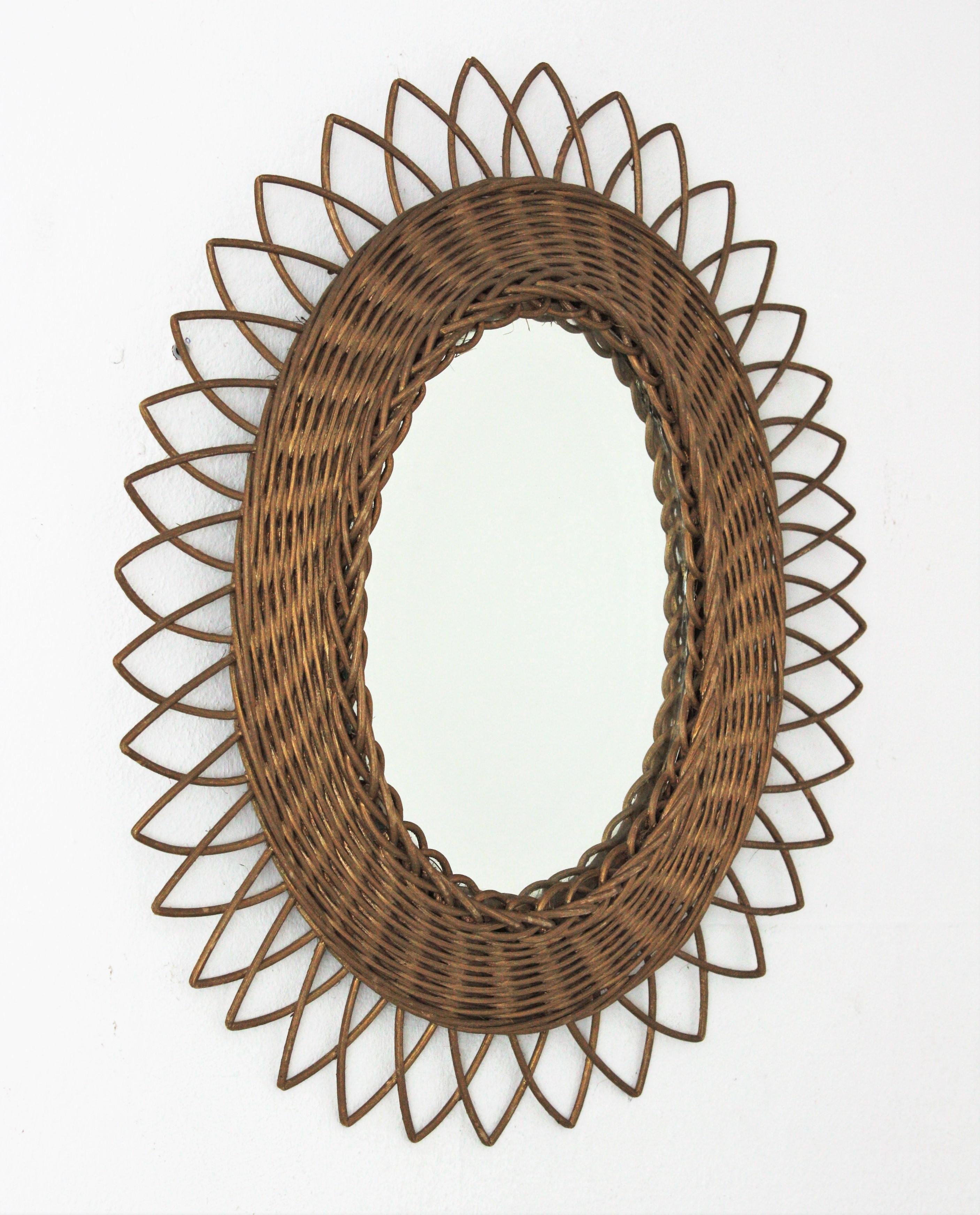 Lovely rattan or wicker mirror with golden paint finishing, France, 1960s.
This handcrafted sunburst mirror has a braided rattan frame. Painted in gold color to add a pinch of glam.
It will be a nice addition to a sunburst mirrors wall