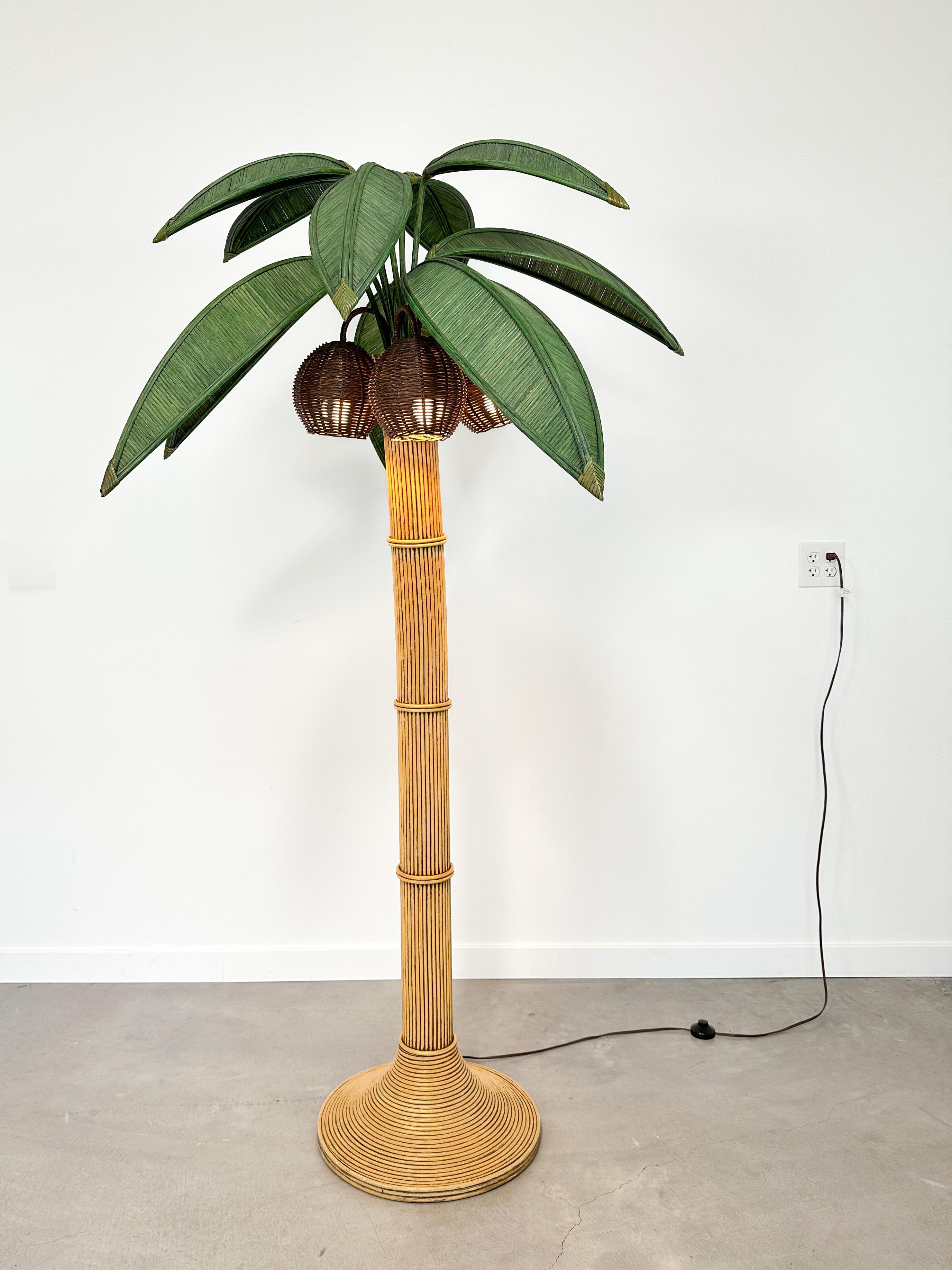 Sculptural, joyful, and unmistakably 1970s, this rattan palm tree floor lamp captures the breezy glamour of vintage Palm Beach, Italian resort interiors, and Hollywood Regency style. With its towering form, handwoven palm fronds, and whimsical