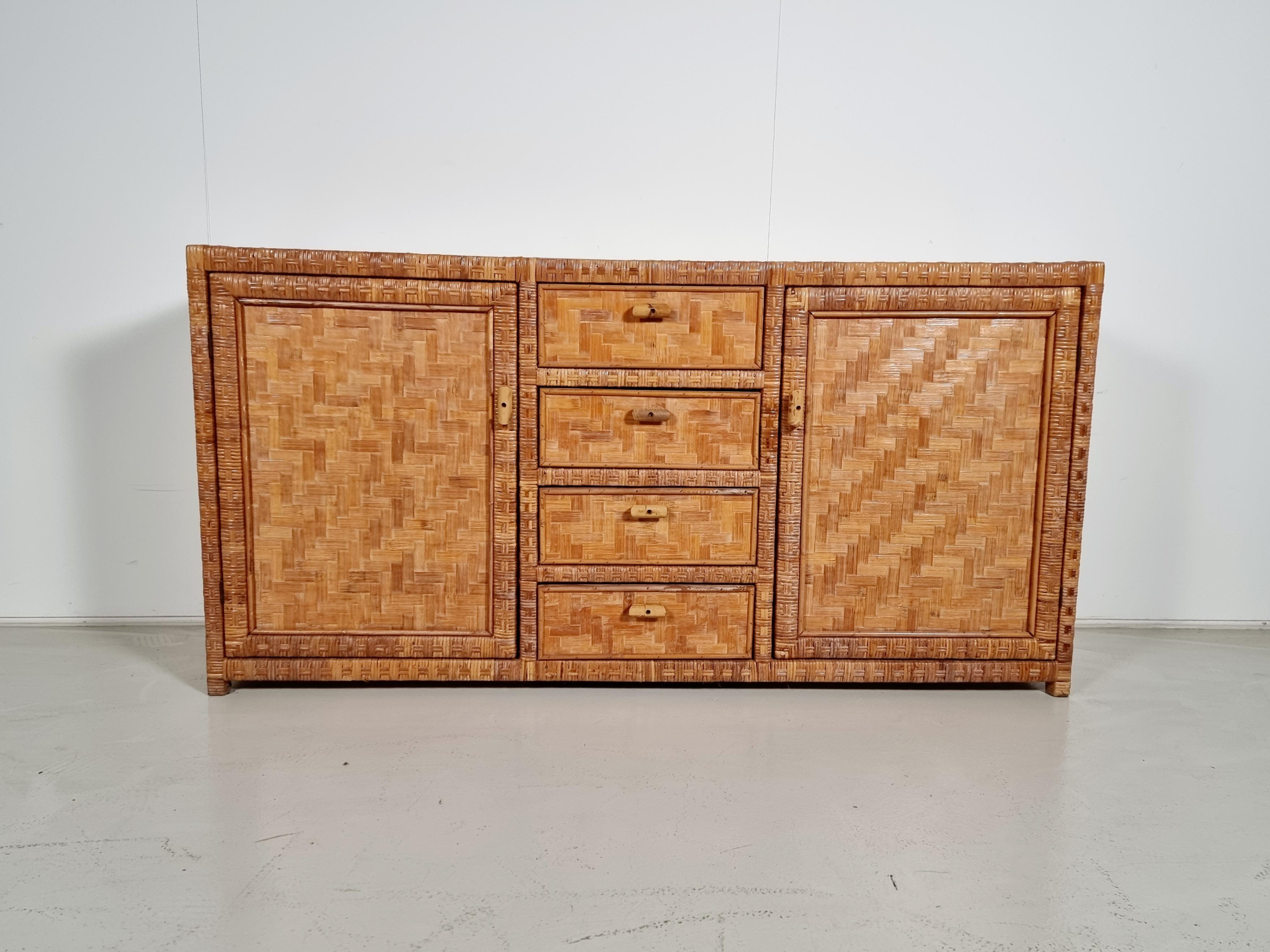 Beautiful Italian rattan herringbone/parquetry sideboard from the 1970s. Well-built and has a great design. The design and the warm tone combined with the Classic features enable it to blend seamlessly with any modern interior.