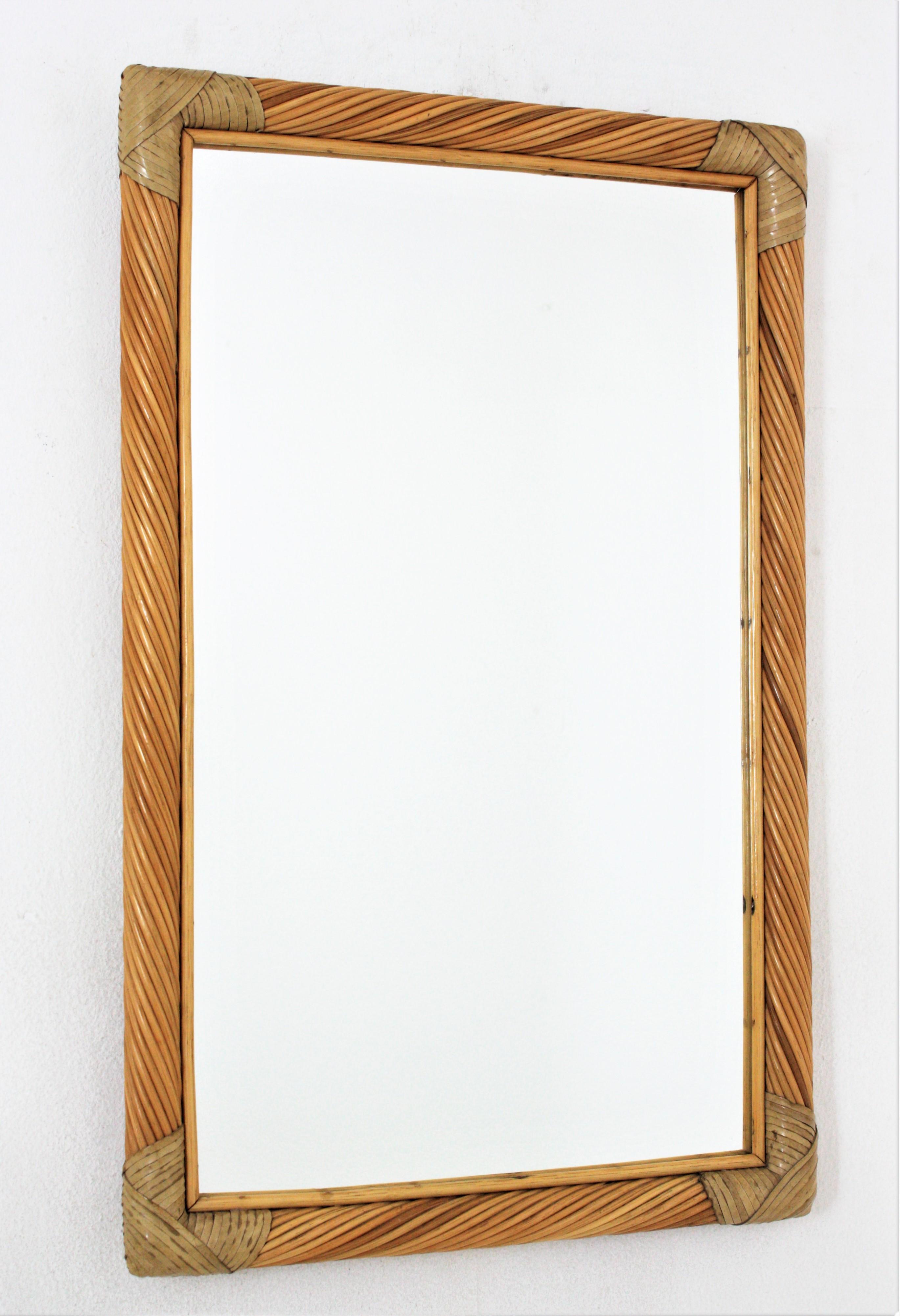 Rectangular wall mirror, Pencil Reed, Rattan, Leather, Italy, 1960s.
Eye-catching rattan mirror. The frame has a nice construction with twisted pencil reed rattan canes. It has leather strip tied details on the corners.
To be used as wall mirror in