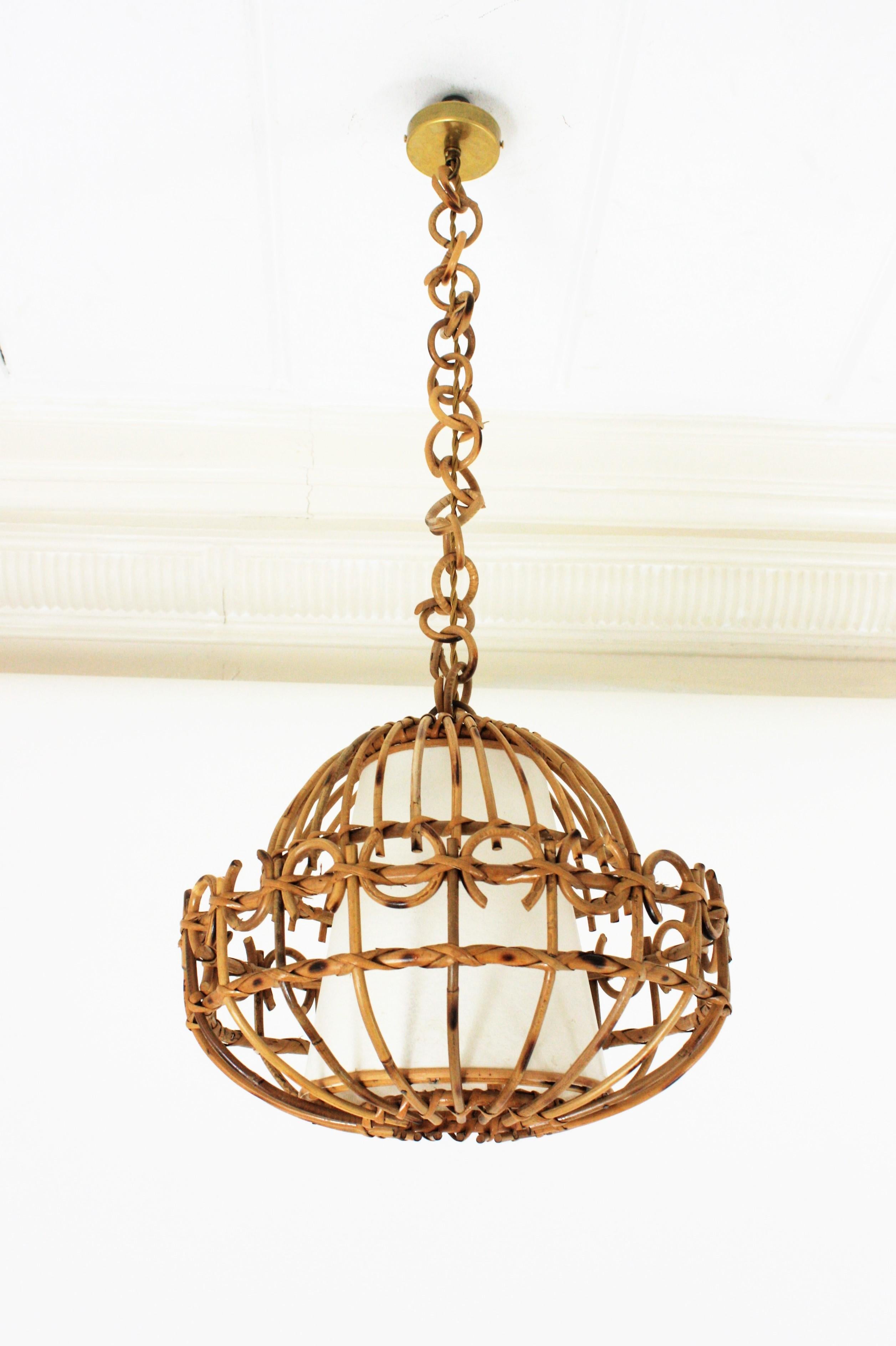 Eye-catching handcrafted rattan ceiling pendant hanging light, Spain, 1960s.
This lantern has an beautiful design featuring a semi-spherical rattan structure decorated by semi circle details.
It has a conical paper lampshade at the interior part
