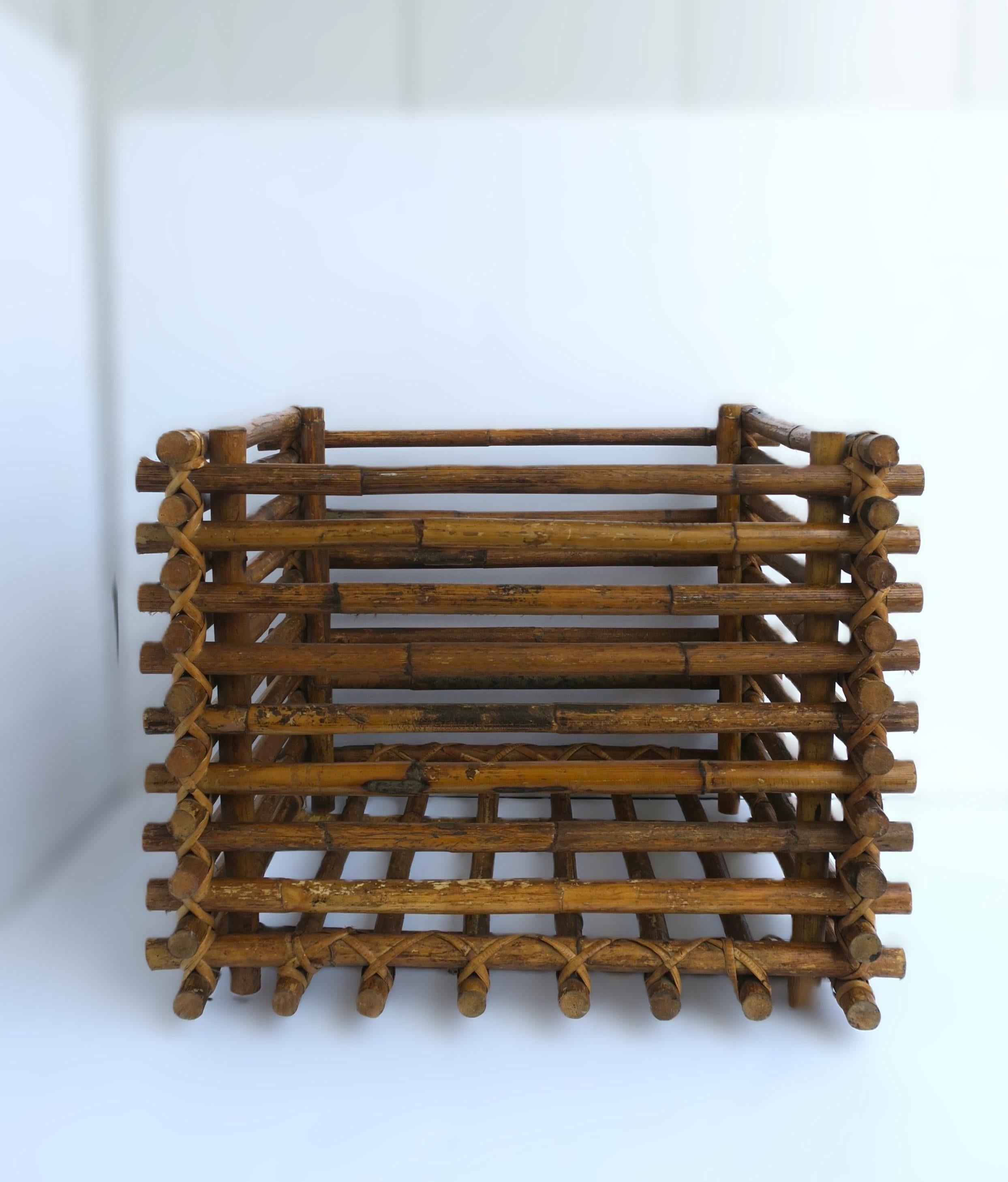 A wicker wrapped square rattan plant or tree holder cachepot. Shown holding faux plant; cachepot can hold larger plant or tree then what I've shown. Piece is a nice size. Internal dimensions: 18.25 x 18.25 x 15.75