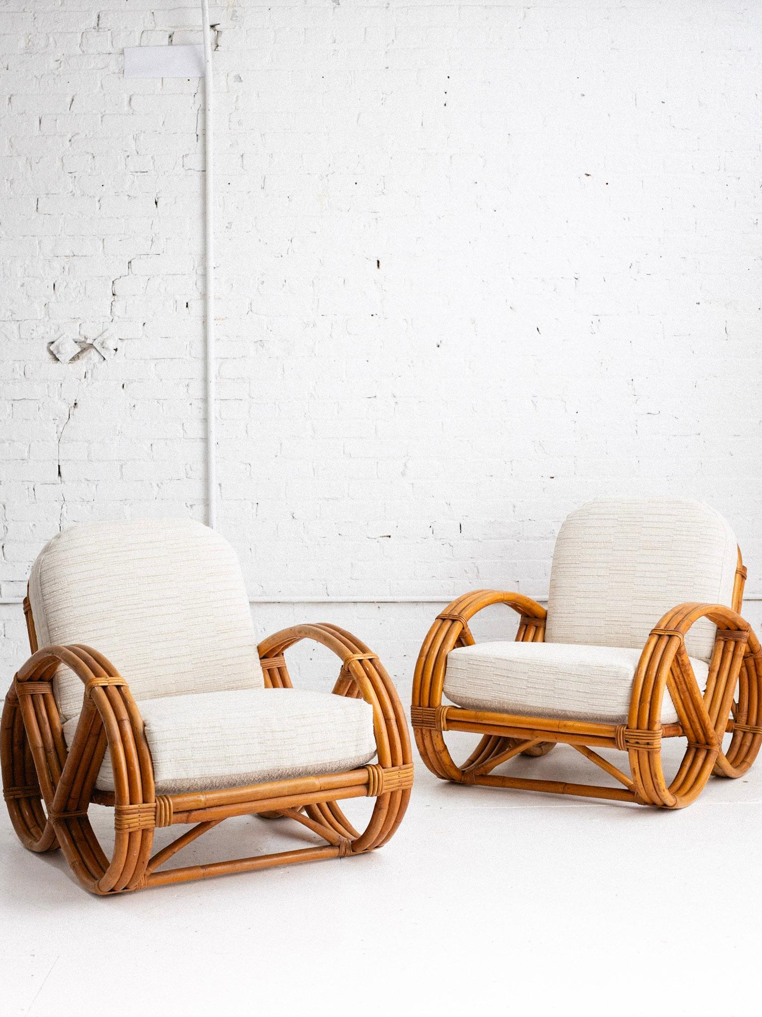 A mid century rattan pretzel chair in the style of Paul Frankl. Classic 1940s rattan silhouette. New reversible cushions have been added featuring a beige bouclé on one side and a beige textured strip on the other. Only one chair available.