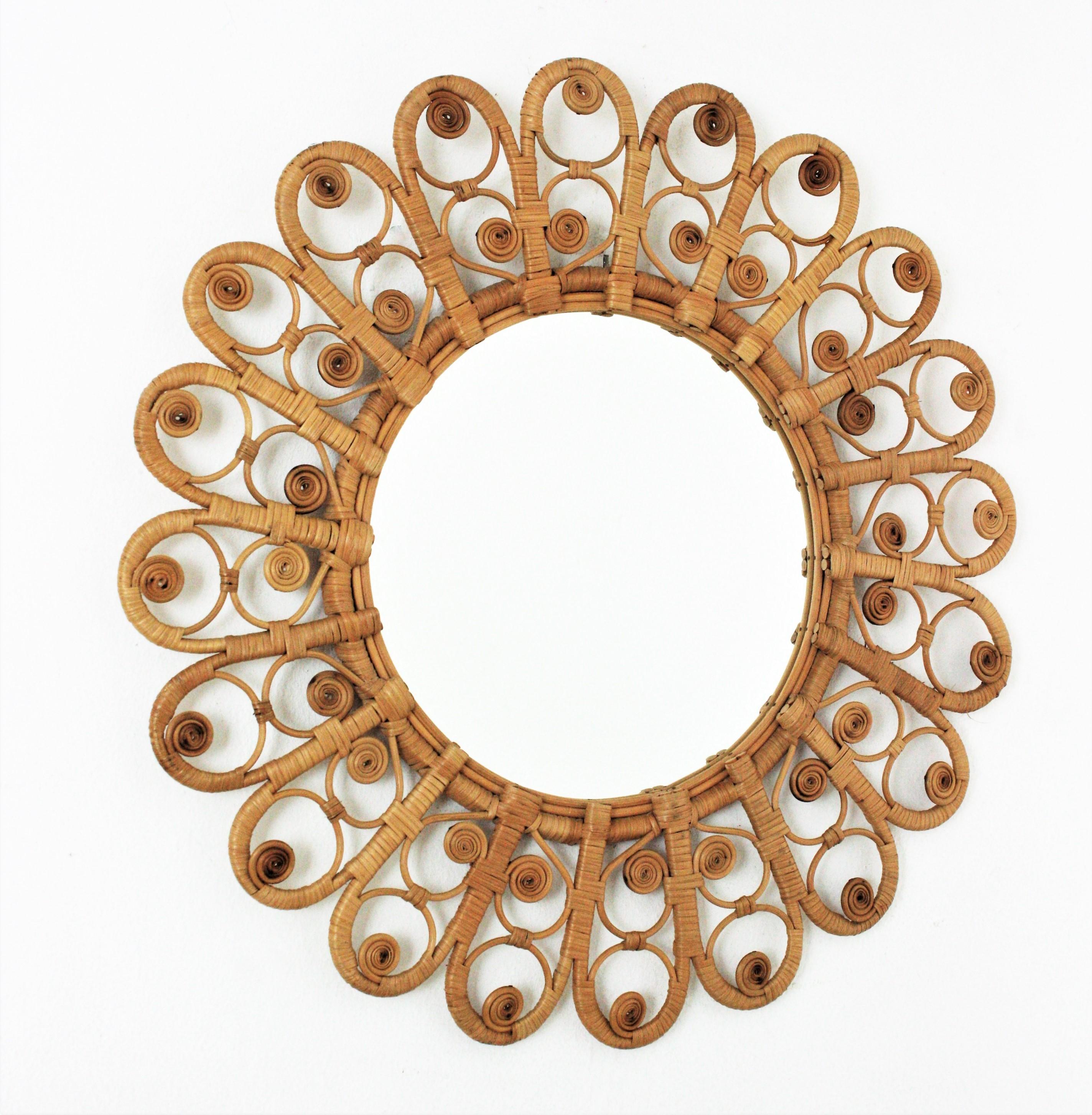 Handcrafte rattan sunburst flower mirror with peacok filigree frame. Spain, 1960s.
This mirror has all the taste of the Mediterranean and bohemian style and reminiscences in design of the Peacock chairs.
Manufactured in wicker and rattan with