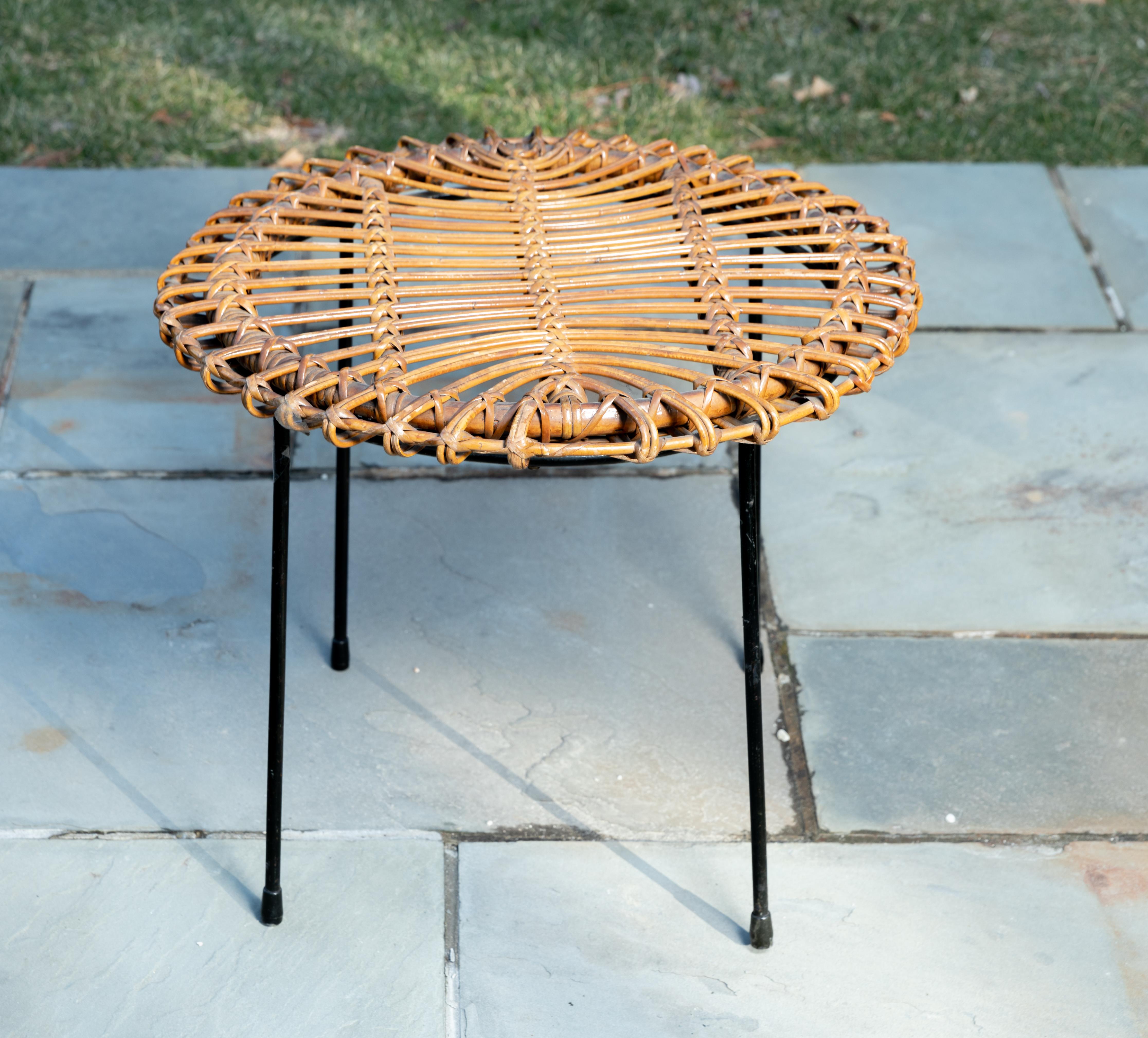 Rattan round side table with black metal base.