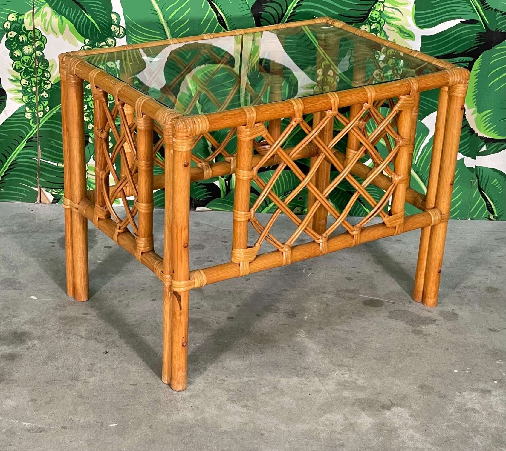 Vintage rattan end/side table features lattice style fretwork and a glass top. Good condition with imperfections consistent with age. May exhibit scuffs, marks, or wear, see photos for details.
 
 