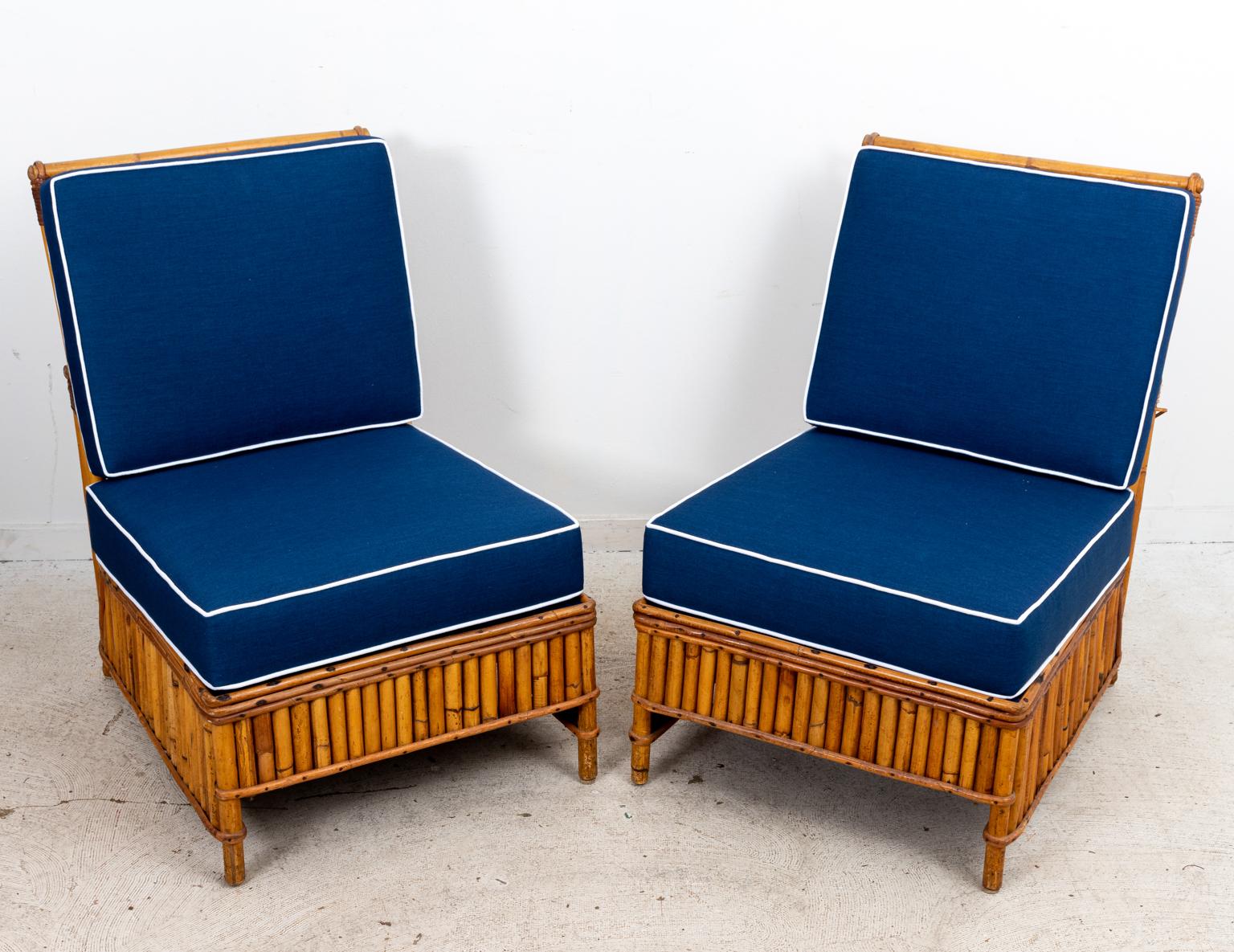 Mid-Century Modern style four piece Rattan Set with two matching side chairs, two matching armchairs, and blue upholstered cushions. The four piece set is designed for multi-functional use and can be re-arranged to accommodate two to four people.