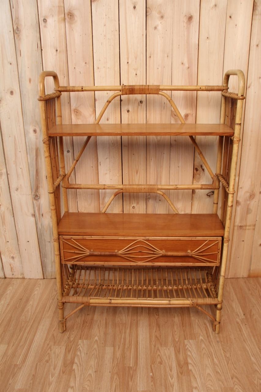 Beautiful shelf/bookcase on rattan feet. Vintage 60/70 period. Equipped with a drawer with two beautiful rattan handles with an original design. With two wooden shelves. This shelf can be placed in any room in your home (bedroom, living room,