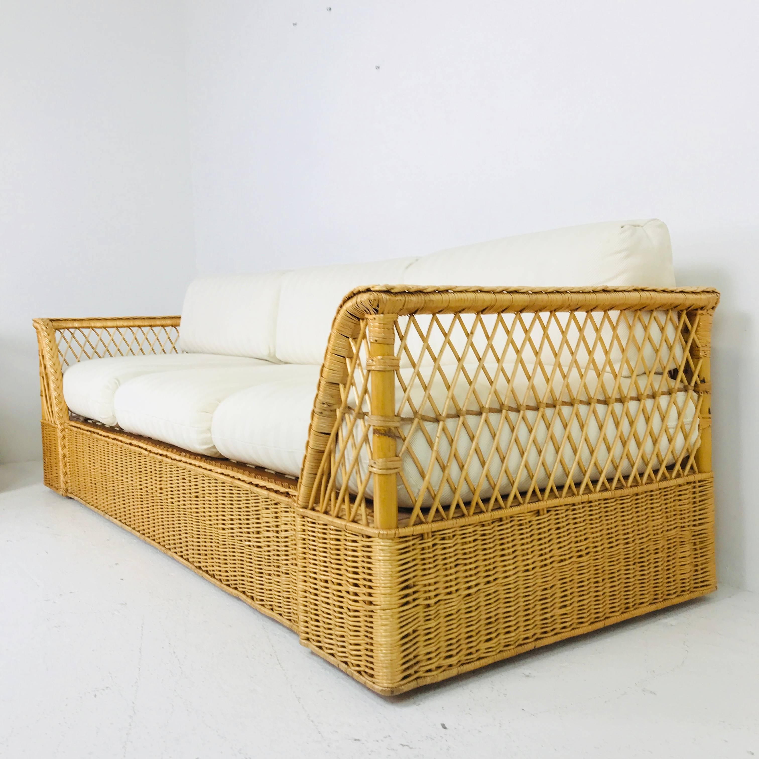 Rattan Sofa with Upholstered Cushions by McGuire. In good vintage condition with minor repairs.

see our other listing for the chair

dimensions: 92