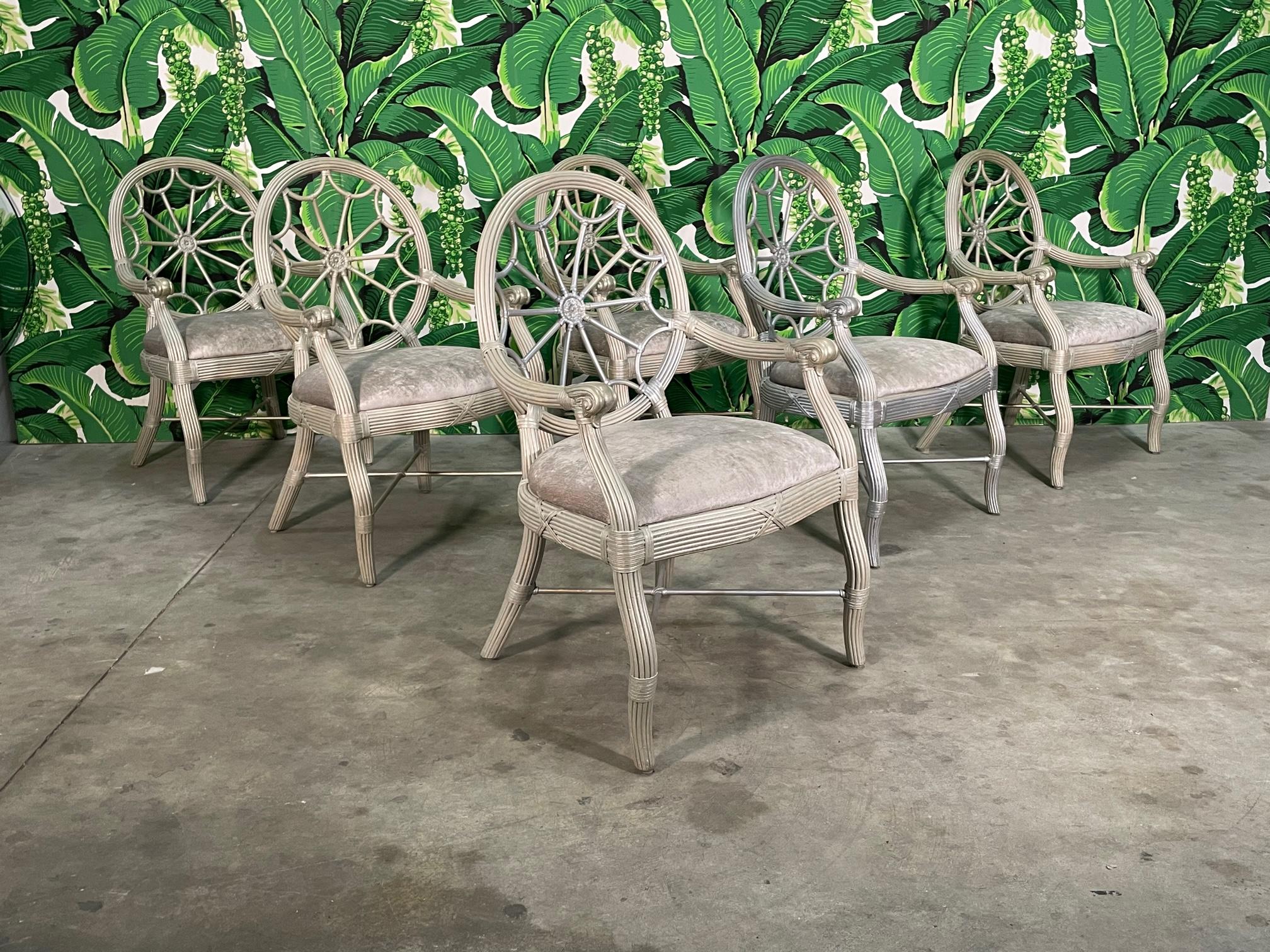 Set of six McGuire style rattan spider back dining chairs features a pencil reed rattan with leather bindings. X stretchers along with splayed rear legs. Upholstered in a matching soft, silver fabric. Good condition with imperfections consistent