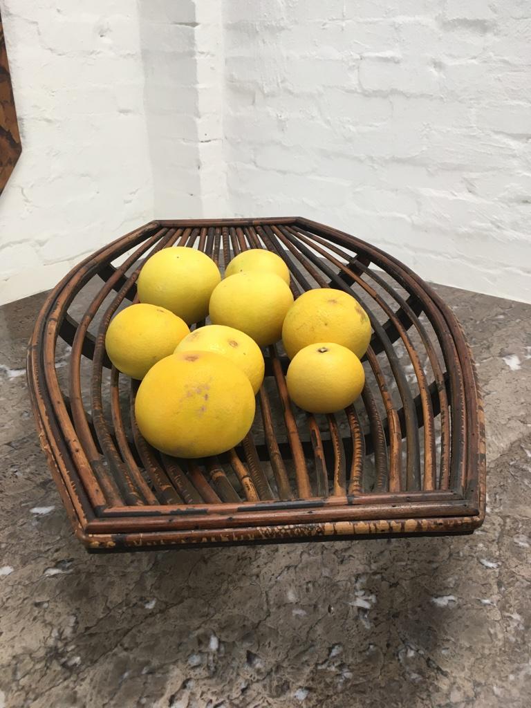 Large and beautifully shaped mid century rattan split cane fruit basket. Constructed of plywood, Sheoak and rattan cane by an unknown designer, possibly in the Philippines .

The grapefruit in this image show the very large scale of the basket.