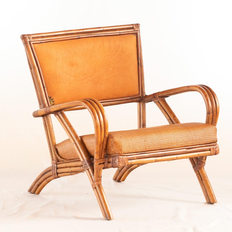 Rattan frame accented with wood and open rattan split weave on its sides and backrest. Modern and confortable chair. 

Modern chair stamped for Kalma in Bamboo Wood, 20th century. Collapsible rattan base reinforced with wrought iron. Seat is
