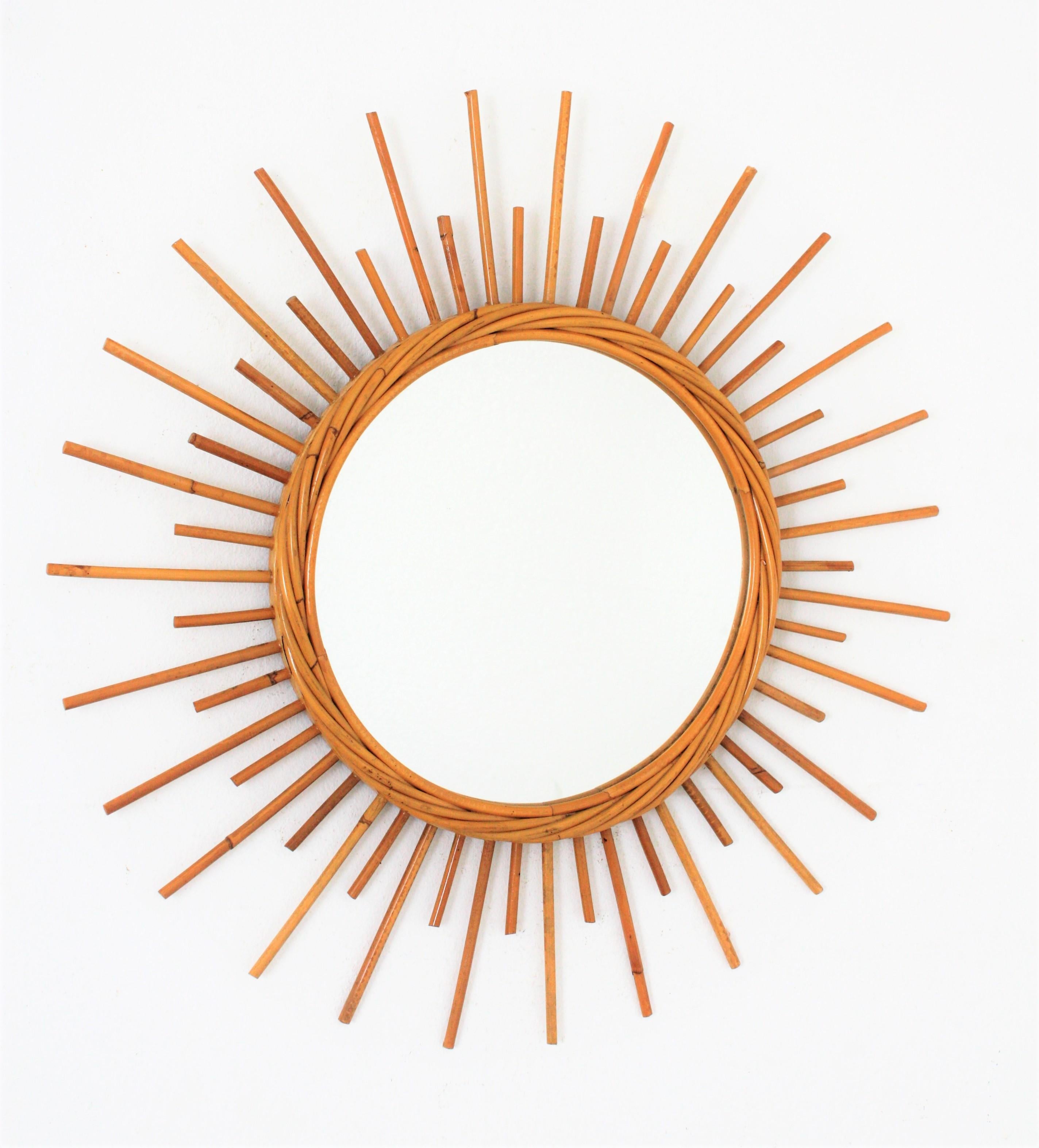 Lovely rattan sunburst or starburst wall mirror from the French Mediterranean Coast. France, 1960s.
Beautiful to place in a wall decoration with other bamboo, rattan or wicker mirrors, but also lovely to place it alone.
This piece has all the taste