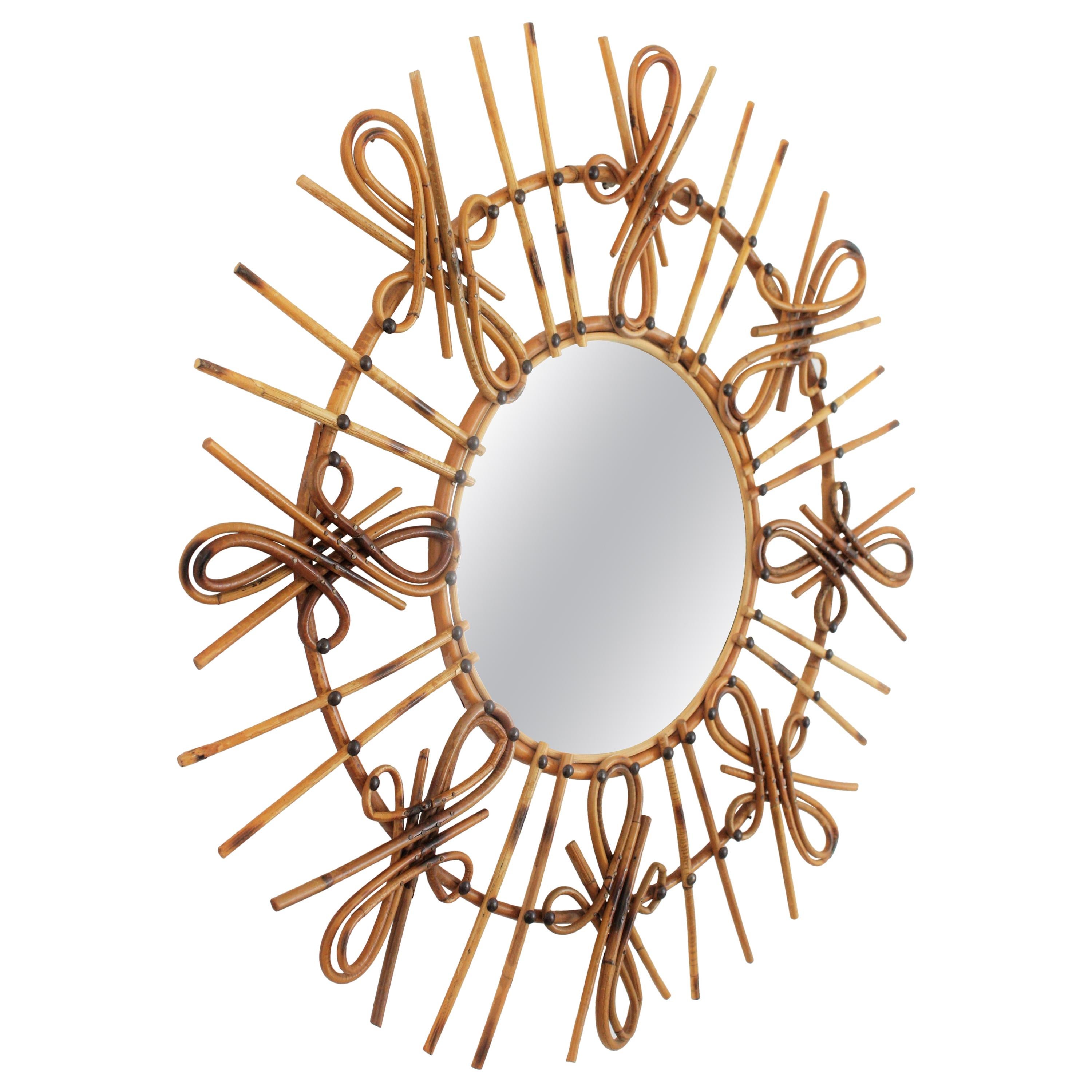 A highly decorative mid-20th century mirror handcrafted in rattan with pyrography decorations and chinoiserie or Tiki accents.
Spain, 1950-1960.
This eye-catching sunburst mirror combines midcentury and chinoiserie accents and it would be a nice