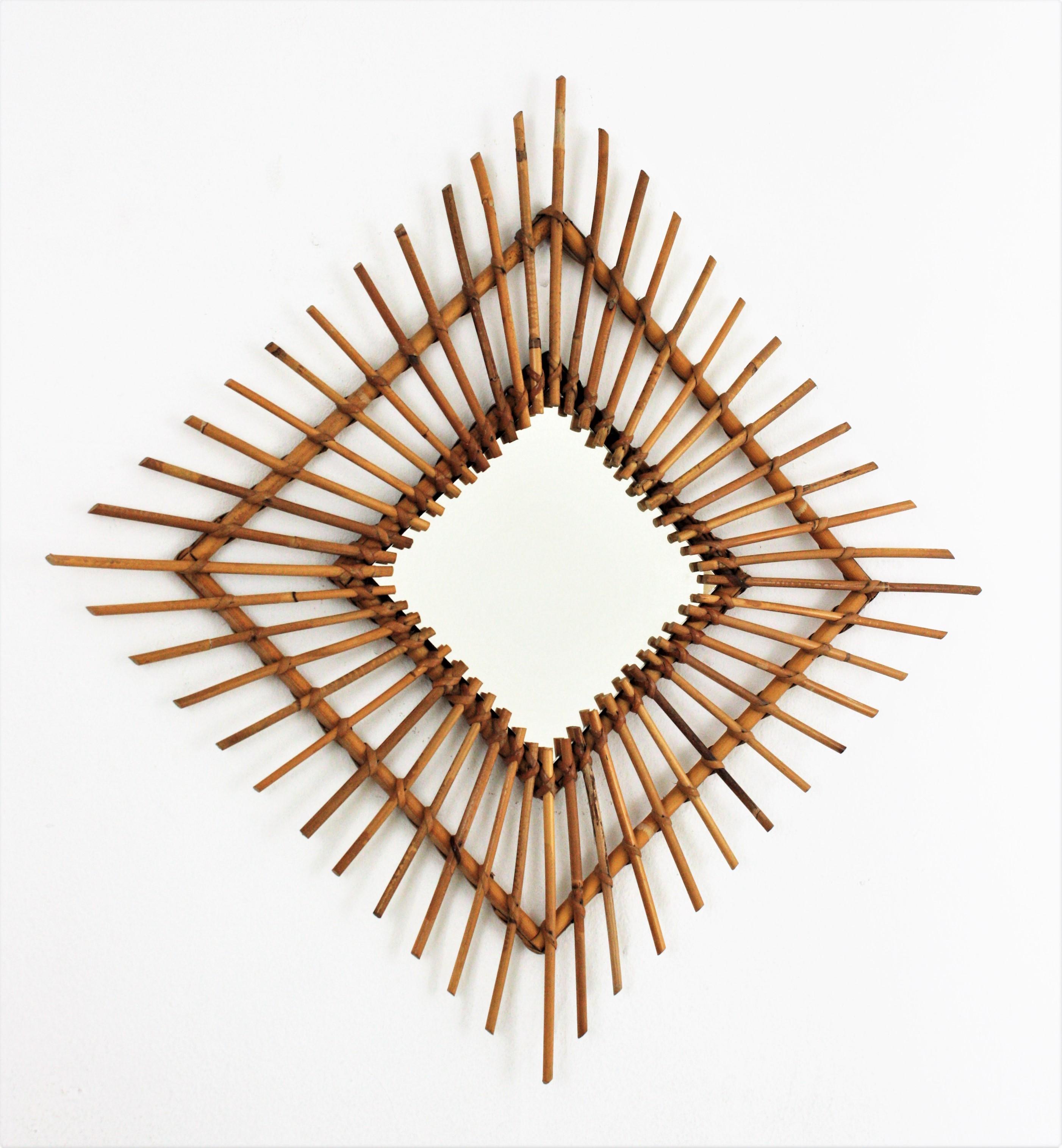 Handcrafted Mediterranean style rattan or wicker cane rhombus shaped mirror, Spain, 1960s.
This rattan mirror can be placed in two positions, as a rhombus or square. It will be a nice choice for a beach house or countryside house decoration or to