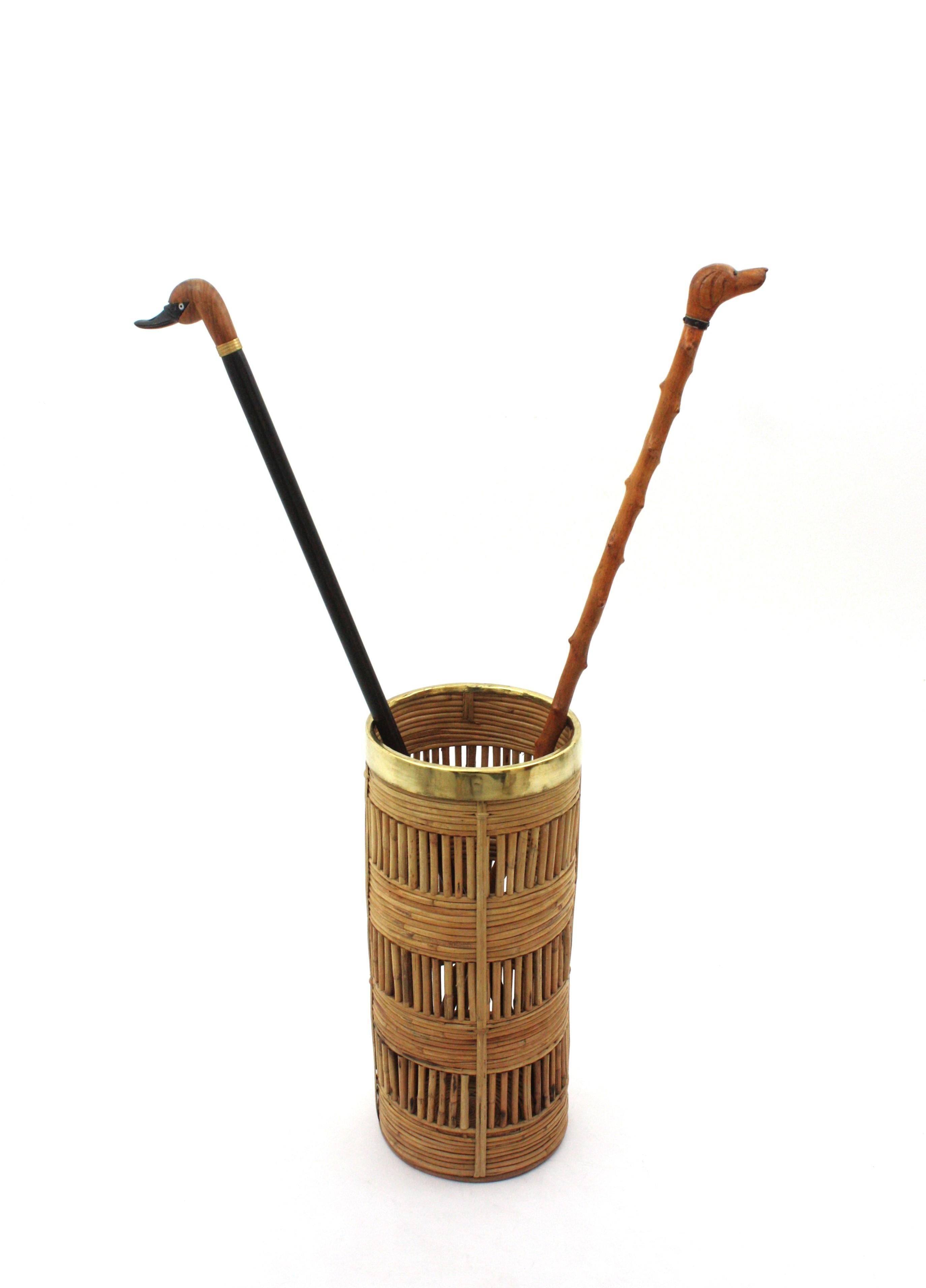 Beautiful Mid-Century Modern decorative brass and bamboo / rattan umbrella stand, tall planter or paper bin. Handcrafted in Italy, 1970s.
Round shape hand woven rattan structure with brass rim. It has reminiscences of Gabriella Crespi designs.
This