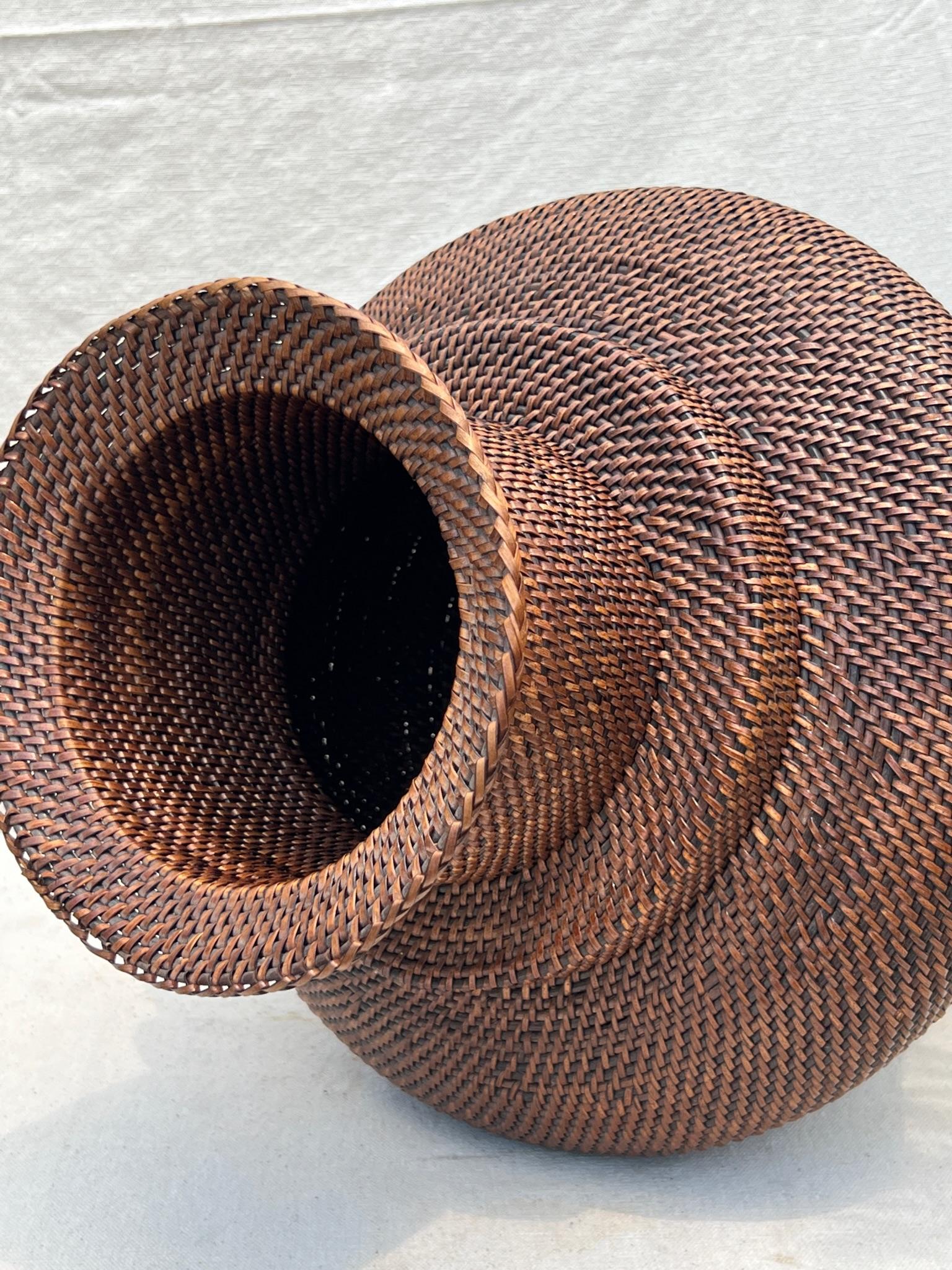 The brown rattan flower vase stands at 13.5 inches tall, and a perfect balance between being a statement piece and a complementary accent to any setting. Its versatile size allows you to display it on your mantel, coffee table, dining table, or as a