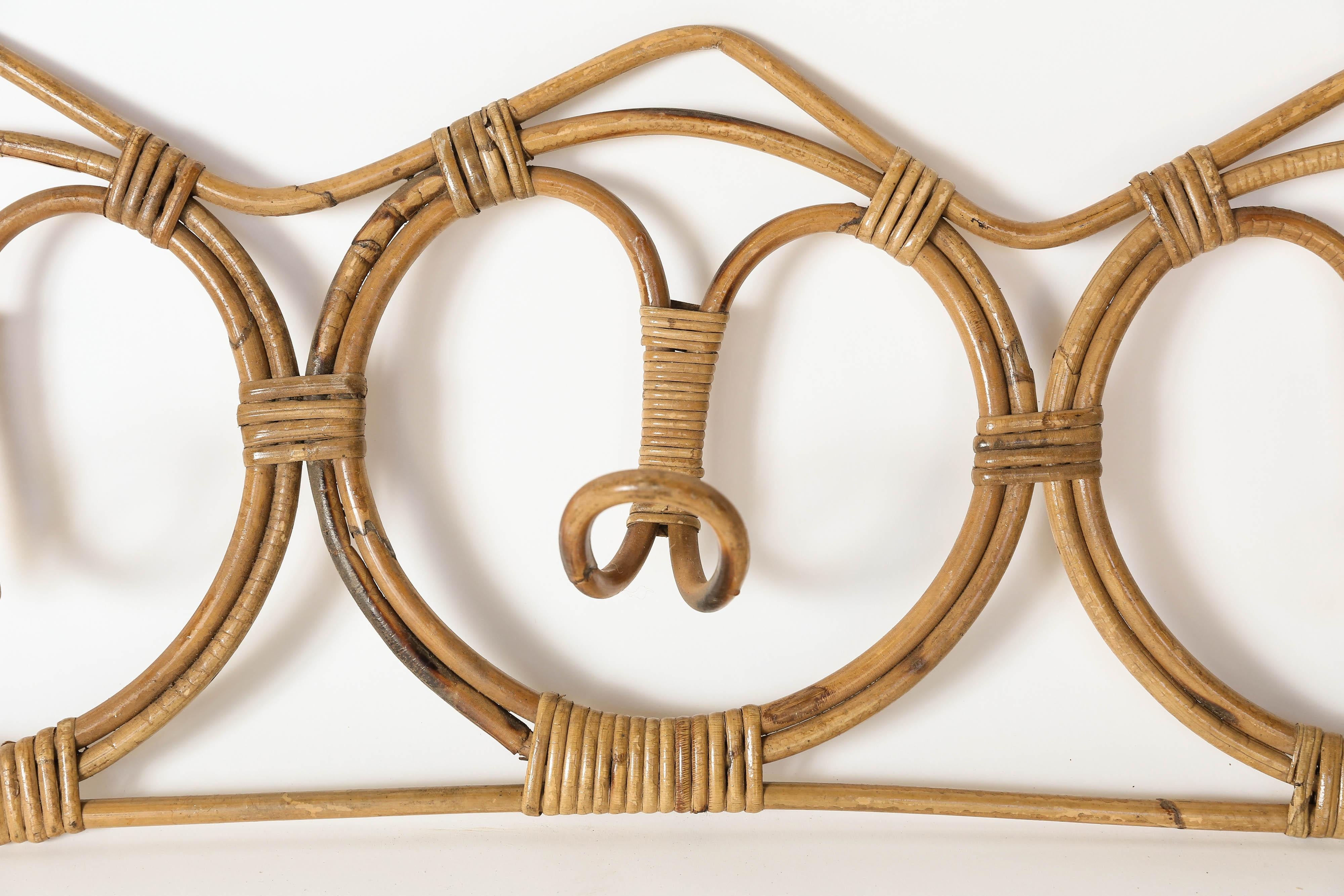 This vintage rattan coat hanger, found in France, is both stylish and functional with three hooks to hold coats and hats. It would be a wonderful addition to the beach or mid century style home.