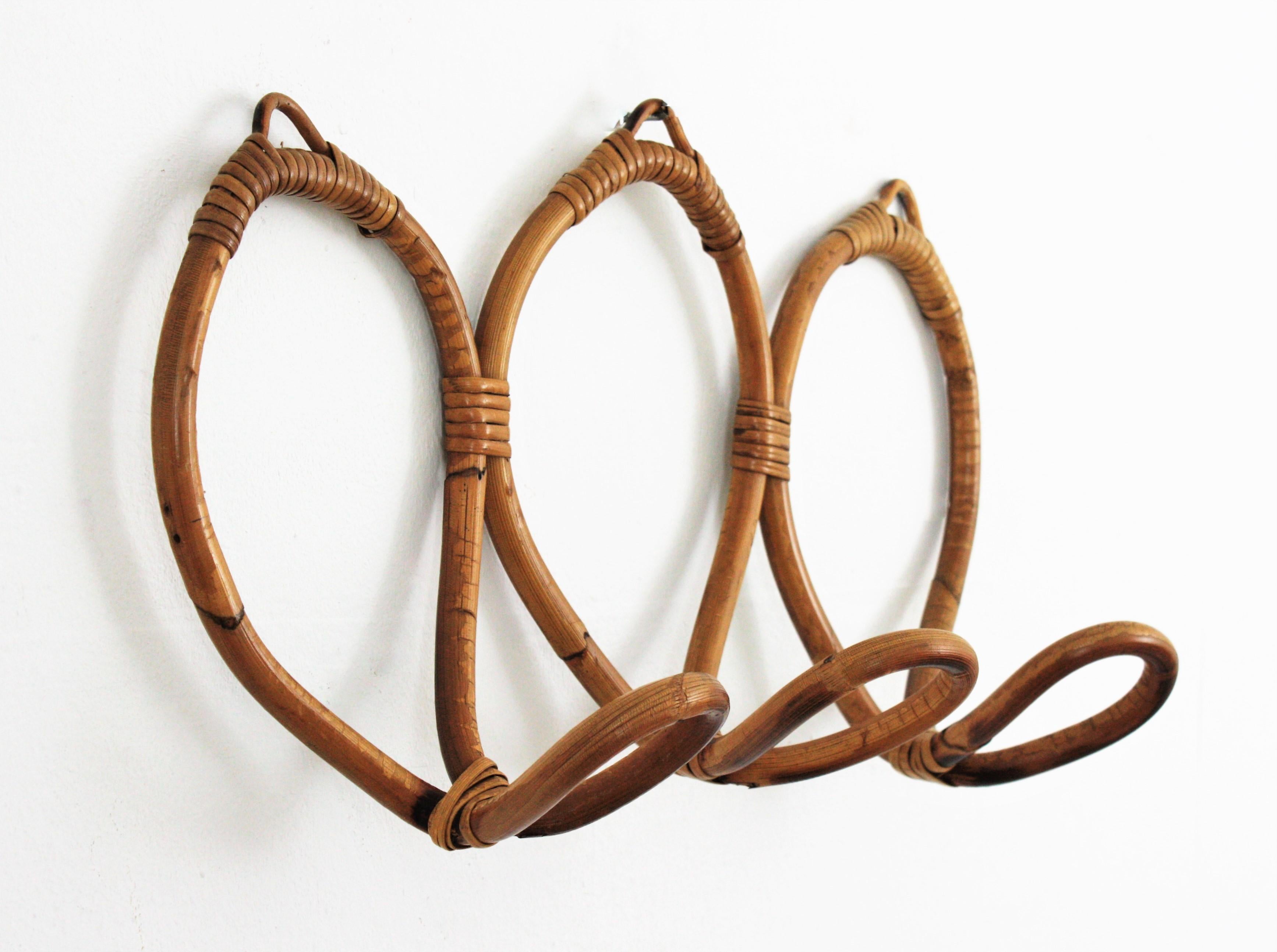 Mid-Century Modern rattan wall coat hook hanger, Italy, 1960s.
This eye-catching wall coat stand features three hooks for hanging clothes, hats or bags.
Its clean design makes it the perfect choice for a minimal modern ambiance. Handcrafted in the