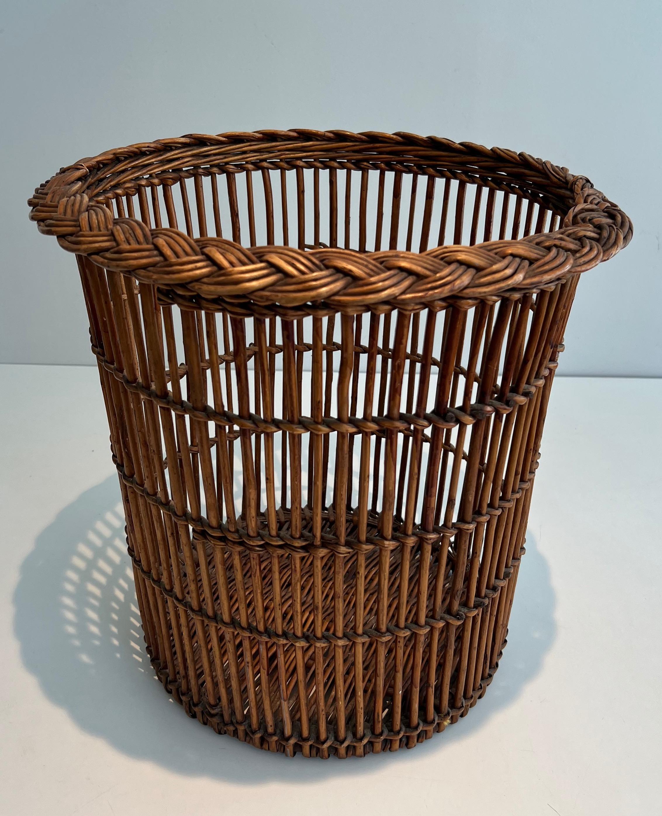 This nice waste paper basket is made of rattan or wicker. This is a fine French work. Circa 1950