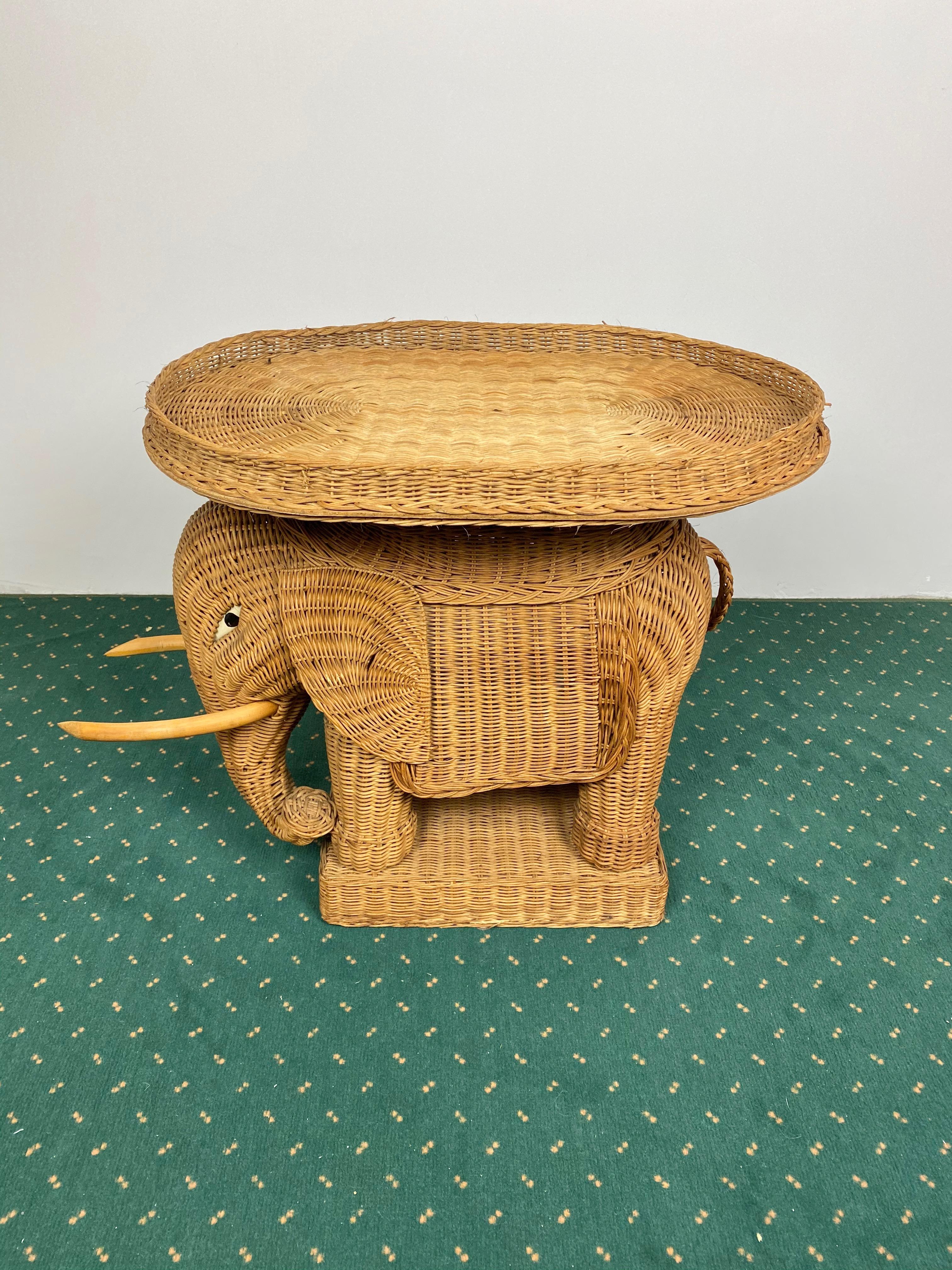 Elephant-shaped end coffee table in hand-braided rattan accented with wood tusks. It also has a removable tray on top of it. Made in France, 1960s.