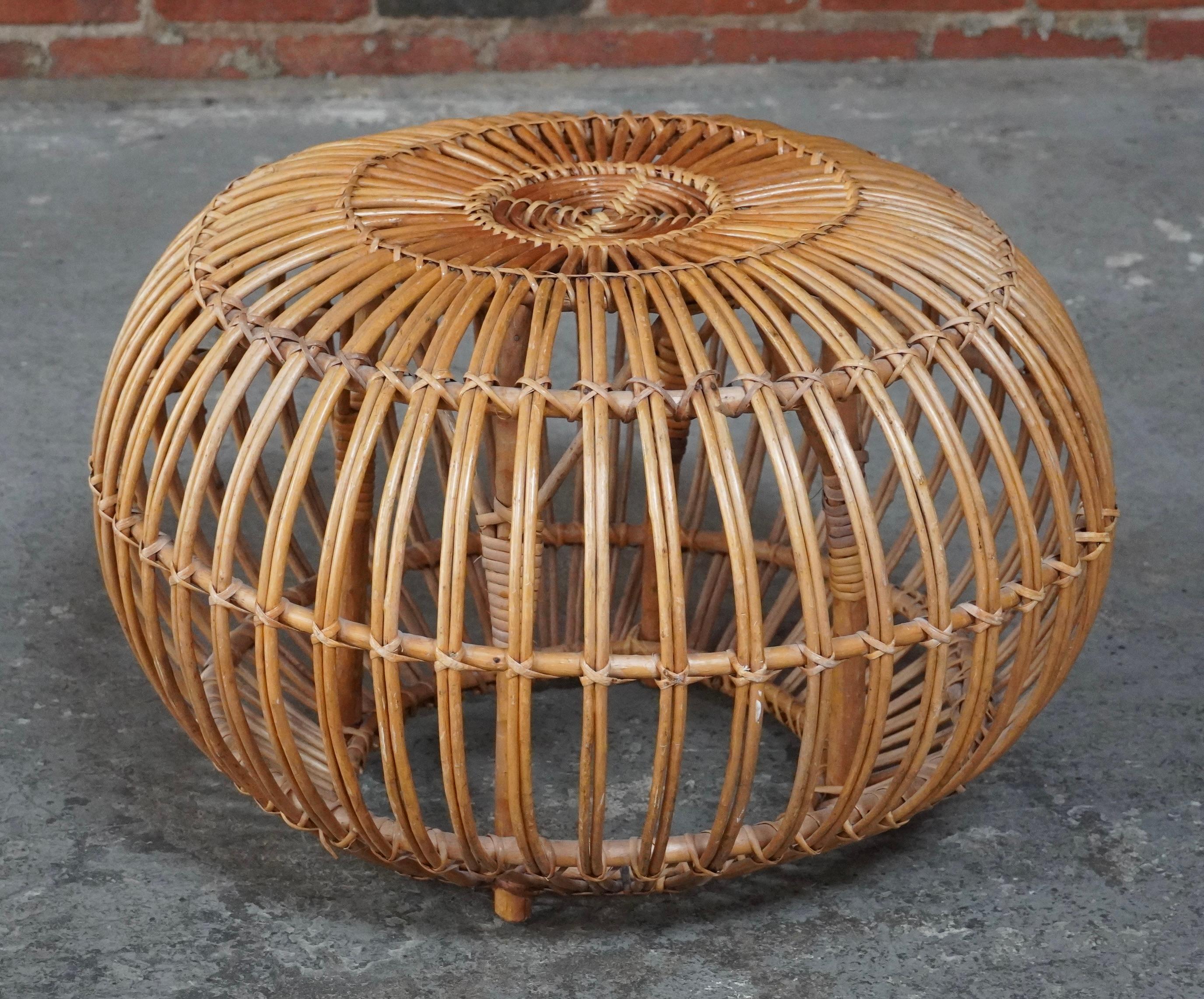 Handcrafted rattan ottoman attributed to Italian architect Franco Albini. The spheric shape is created by a series of steam bent rattan rods that are then fasten together with split rattan strips.