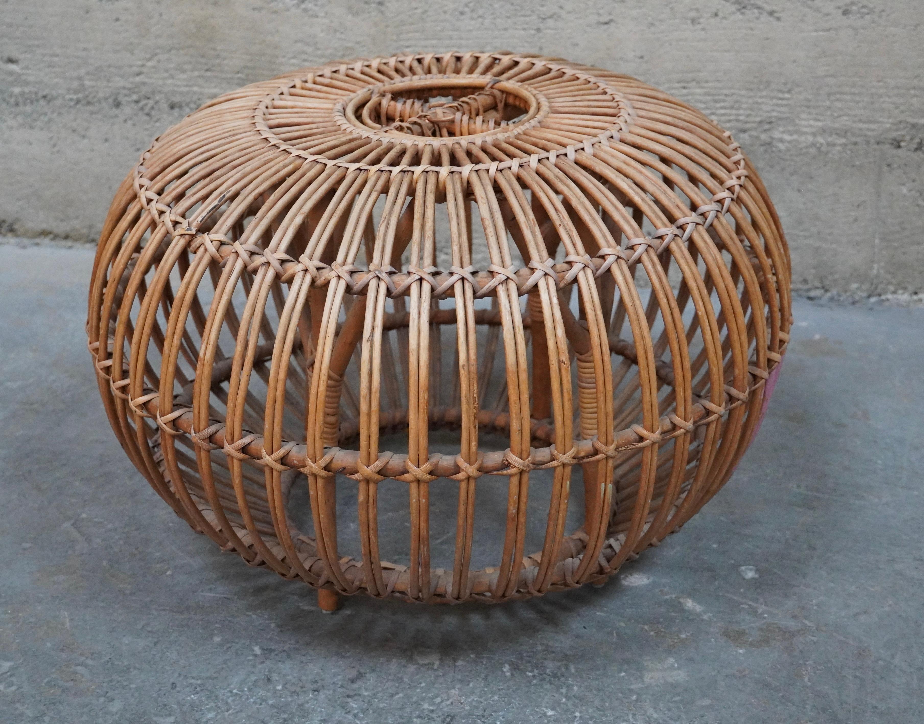 Handcrafted rattan ottoman attributed to Italian architect Franco Albini. The spheric shape is created by a series of steam bent rattan rods that are then fasten together with split rattan strips.