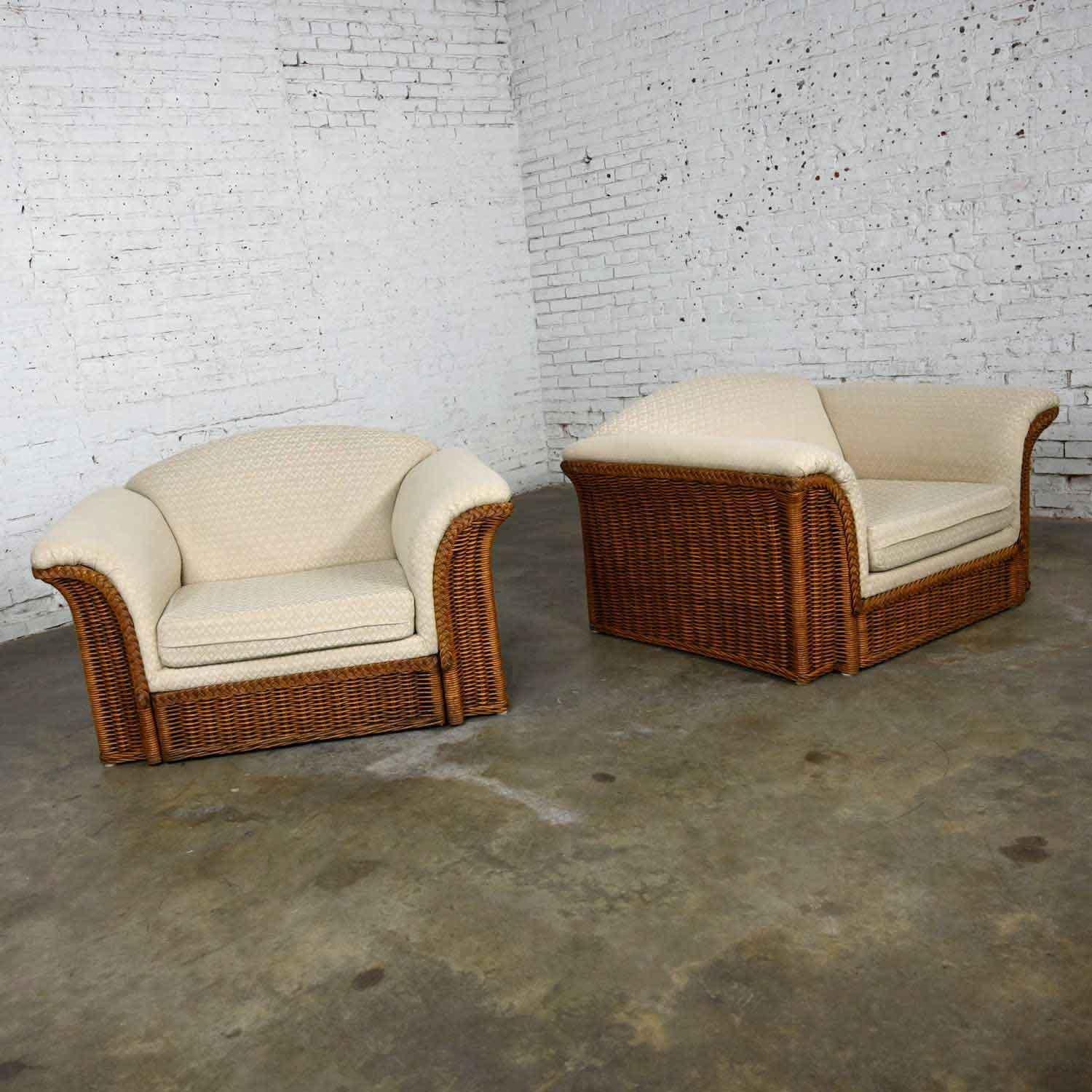 Fabulous pair of rattan wicker oversized lounge chairs wearing their original off-white upholstery in the style of Michael Taylor. Beautiful condition, keeping in mind that these are vintage and not new so will have signs of use and wear. The