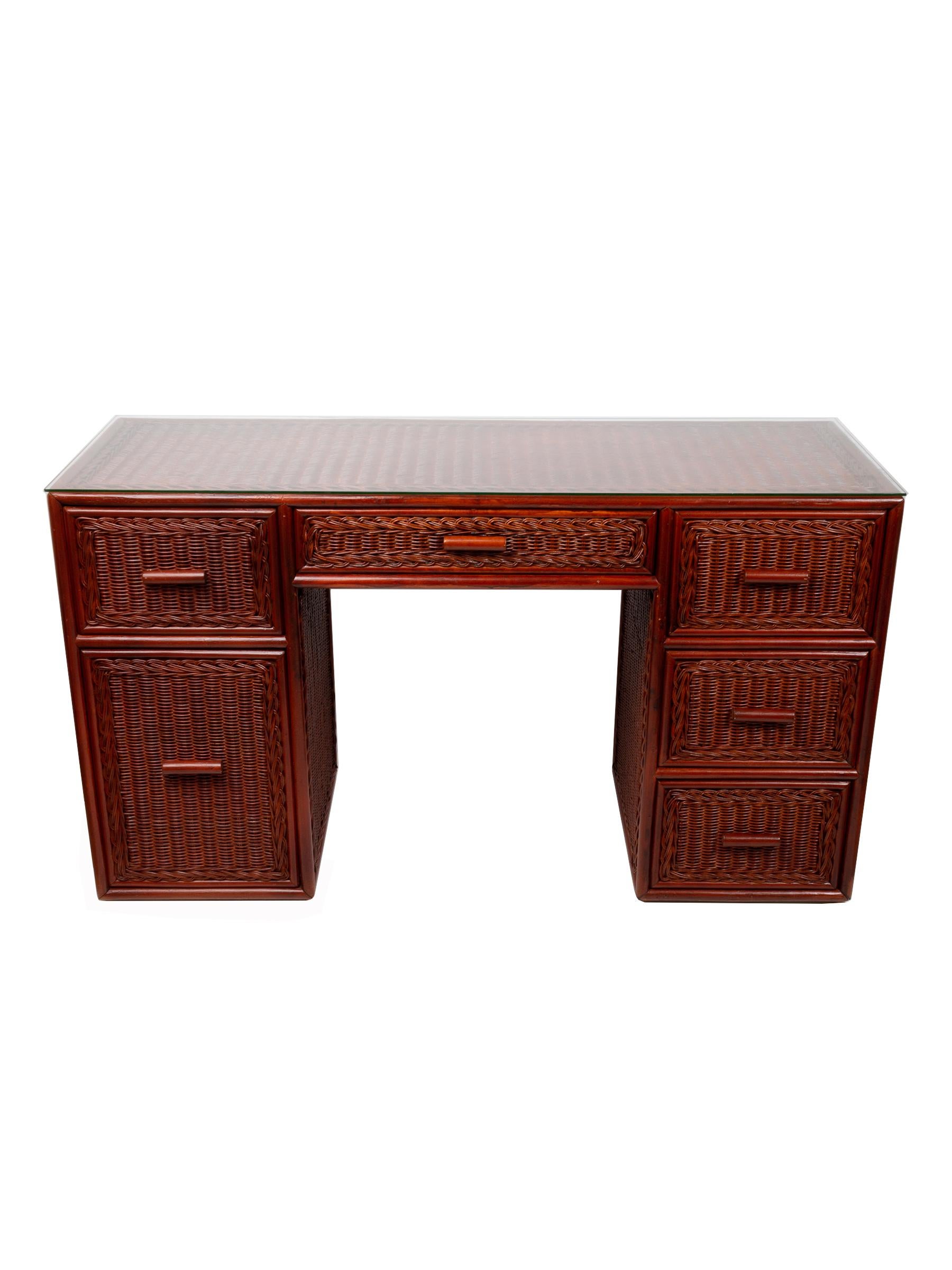 A rattan wicker pedestal desk, Spain, circa 1980.
Comprised of six drawers, one of which is a double deep drawer ideal for files.
Neatly proportioned. Presented with original glass top (micro nibbles to two of the corners, not noticeable,