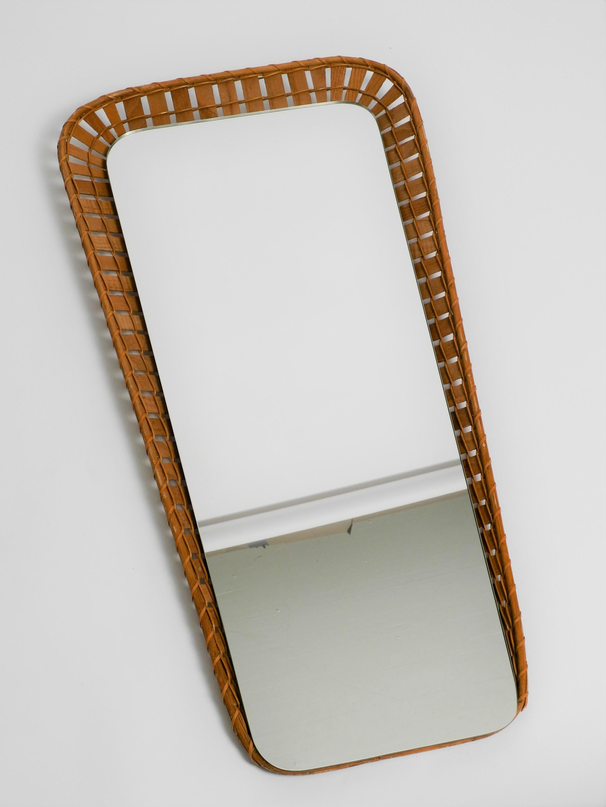 Vintage trapezoidal rattan mirror with wooden back panel, Italy, 70s.

Dimensions:
Total height 82cm/32,3inch
Width top 40,5cm/15,9inch
Width buttom 26cm/10,2inch
Height of mirror 76cm/29,9inch
Width of mirror top 31cm/12,2inch
Width of