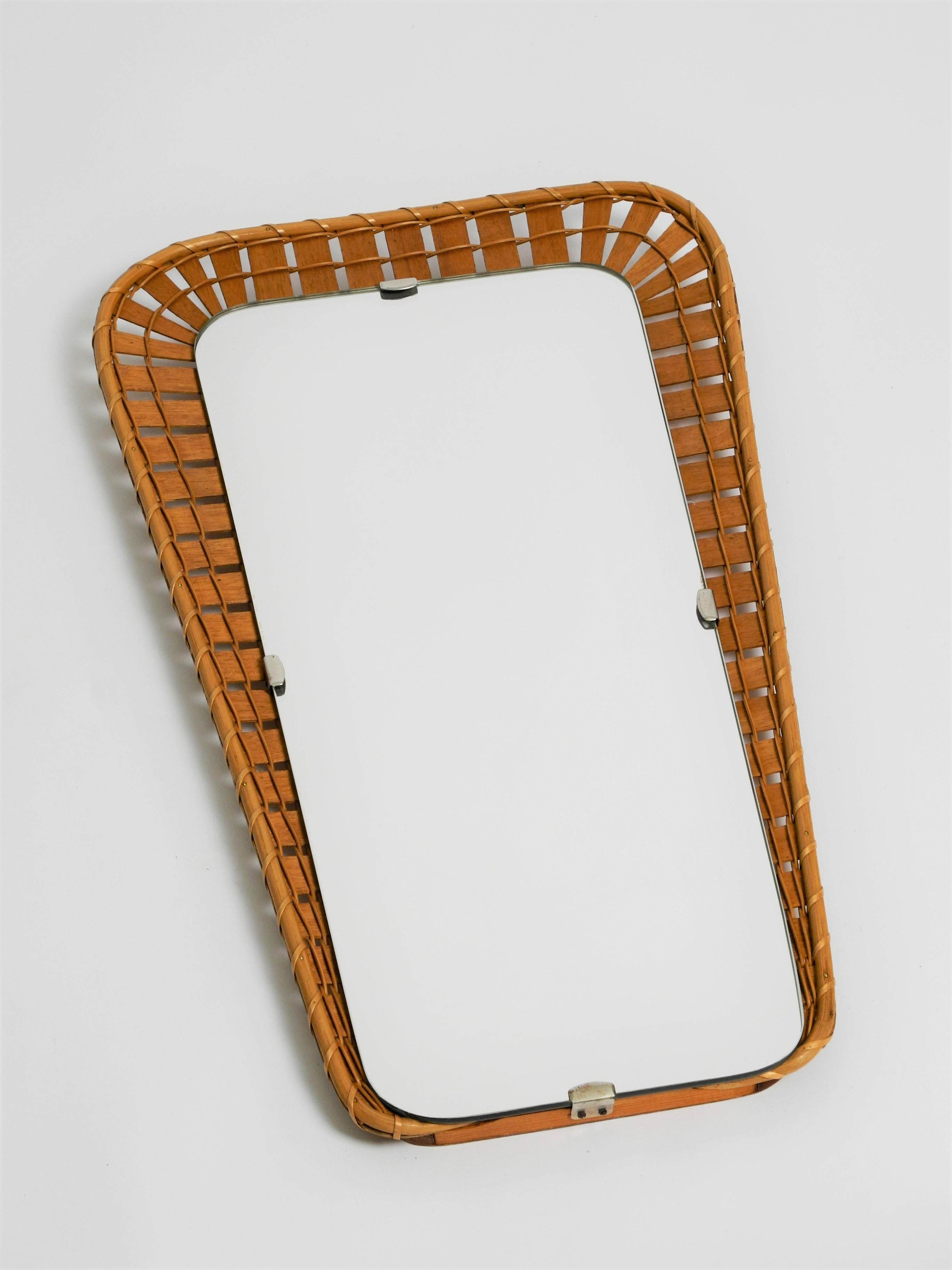 Vintage trapezoidal rattan mirror with wooden back panel, Italy, 70s.

Dimensions:
Total height 60cm/23,6inch
Width top 35cm/13,8inch
Width buttom 22cm/8,7inch
Height of mirror 54cm/21,3inch
Width of mirror top 24,5cm/9,7inch
Width of mirror buttom