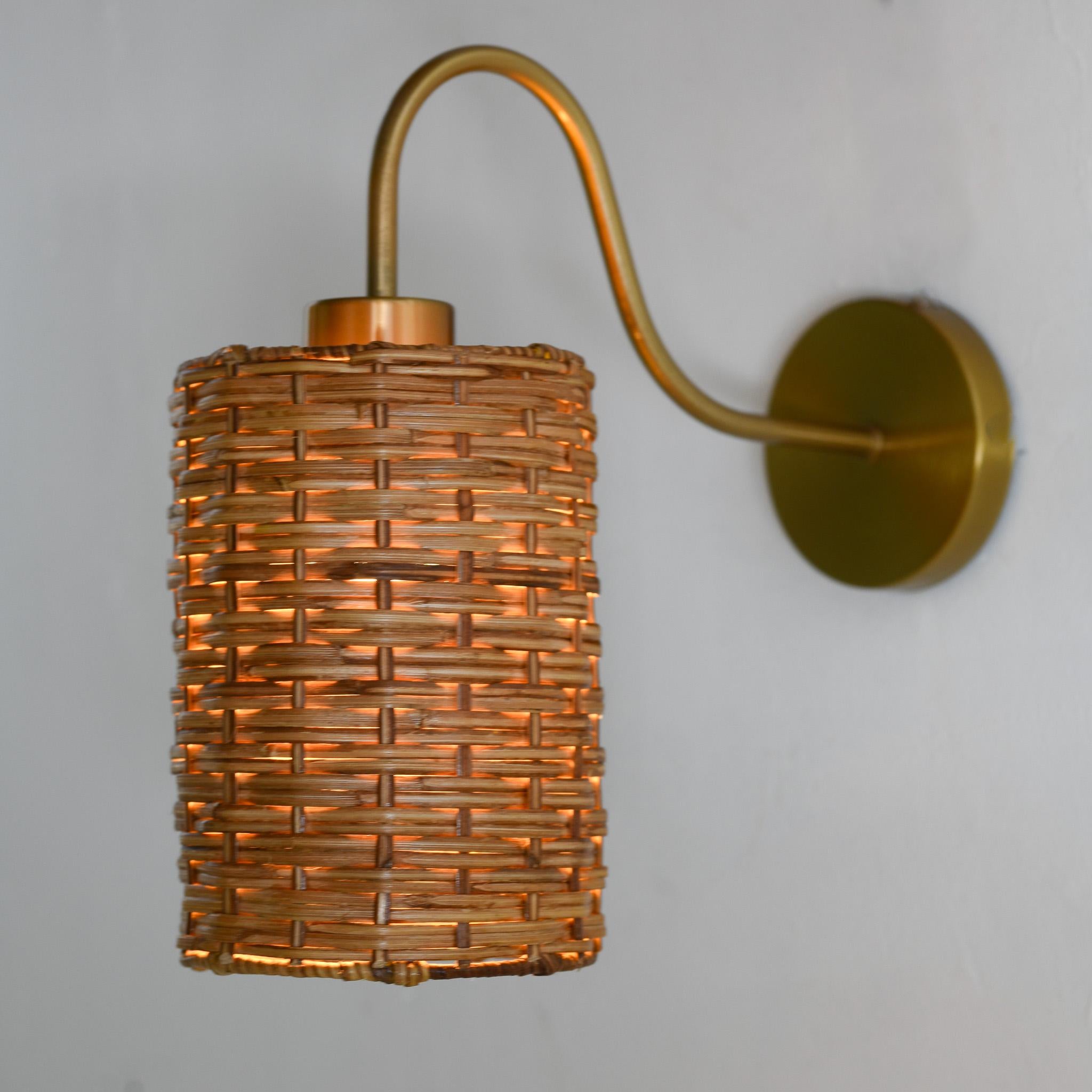Illuminate your bathroom or bedroom with this eco-friendly wicker wall sconce lamp. Handcrafted with natural materials and adorned with a touch of gold, this modern light adds a luxurious touch to your decor. Elevate your space with this