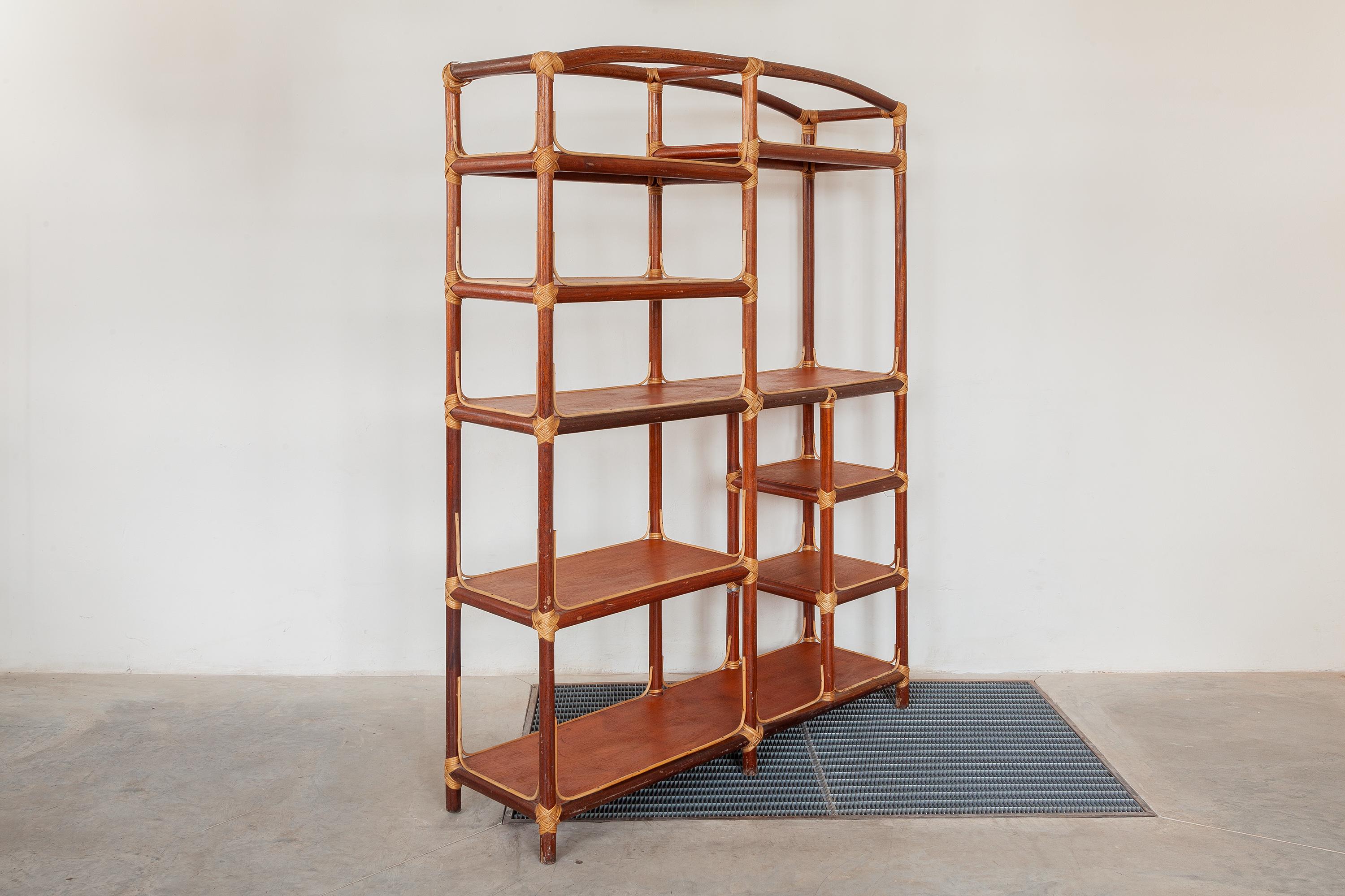 Vintage midcentury display shelf. Teak shelves are woven onto a sturdy bent bamboo frame. This Bamboo bookshelf is a great piece of bamboo furniture makes a great boho chic vintage look. Made in Italy, 1970s. Dimensions: 138 W x 185 H x 38 D cm.