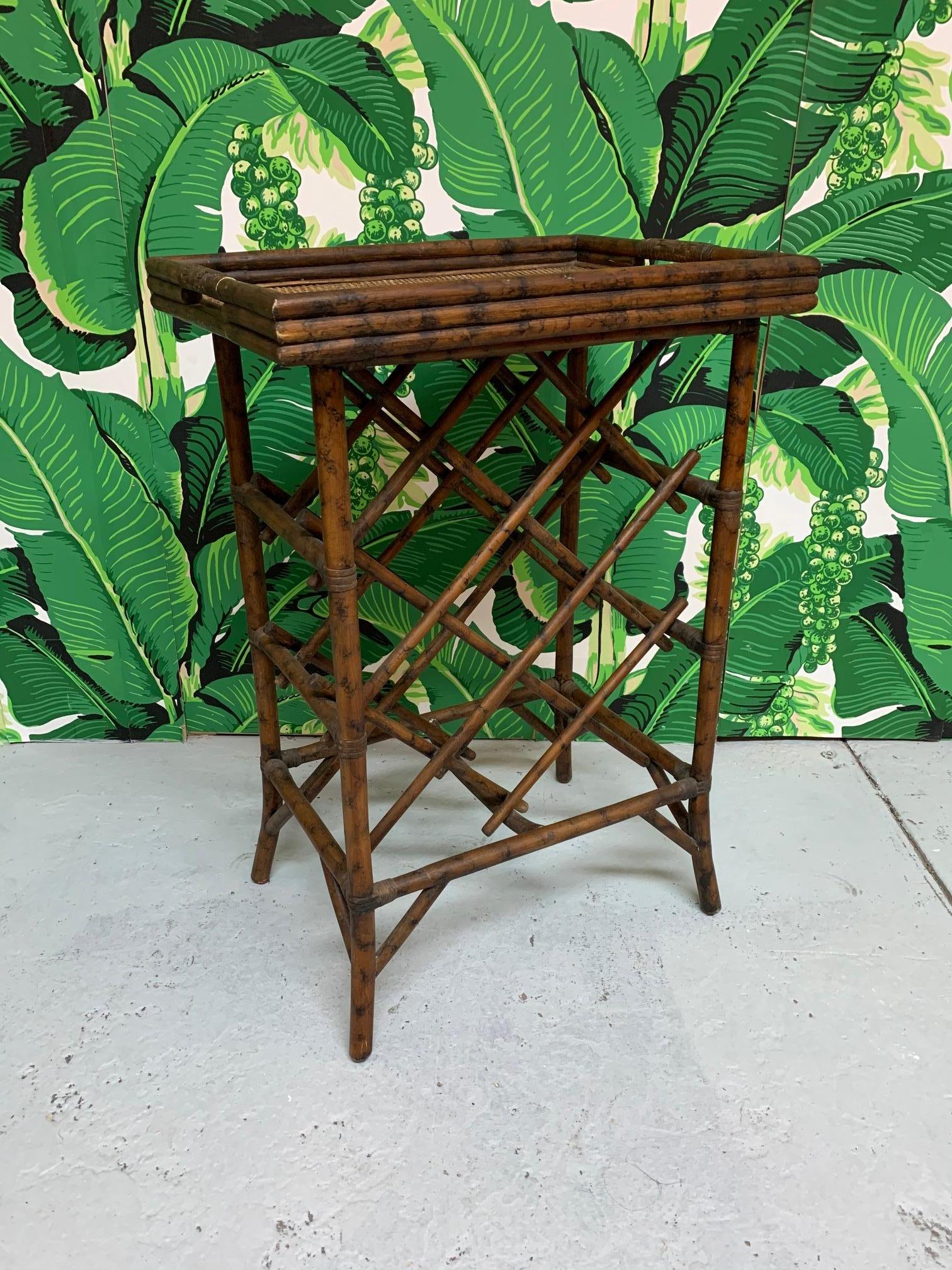 Vintage rattan wine rack doubles as a table with removable serving tray. Holds 7 bottles, and more libations can be displayed on the top tray. Very good vintage condition with age appropriate patina.