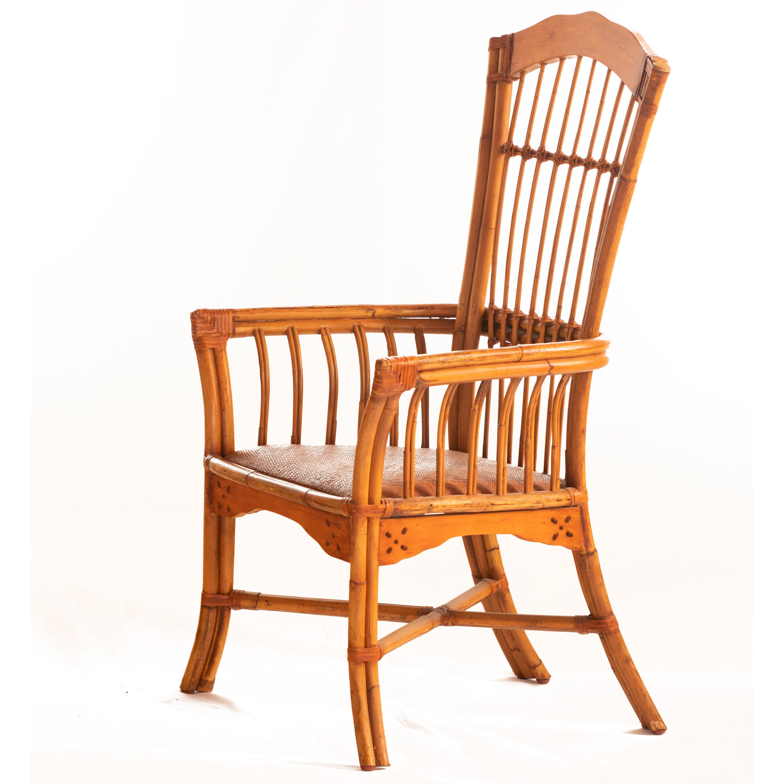 Armchair in rattan, seat upholstered in woven cane, backrest in woven leather. Light brown.

High quality bamboo and rattan collection. Design armchairs of the 20th century. Bamboo wood furniture with wicker seats. Armchairs of particular