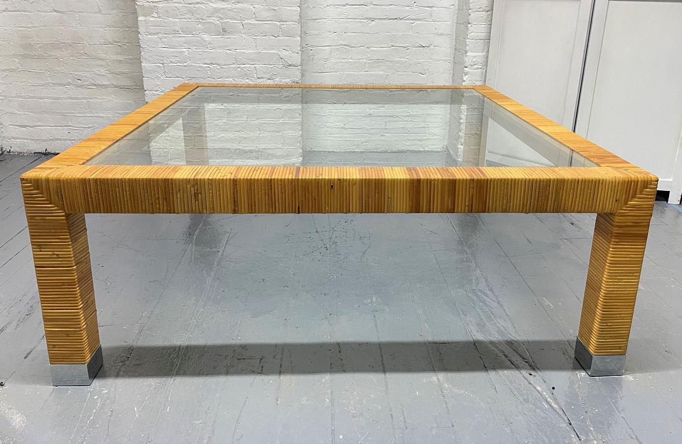 1960s, Rattan Wrapped coffee table with a glass insert top with chrome feet.