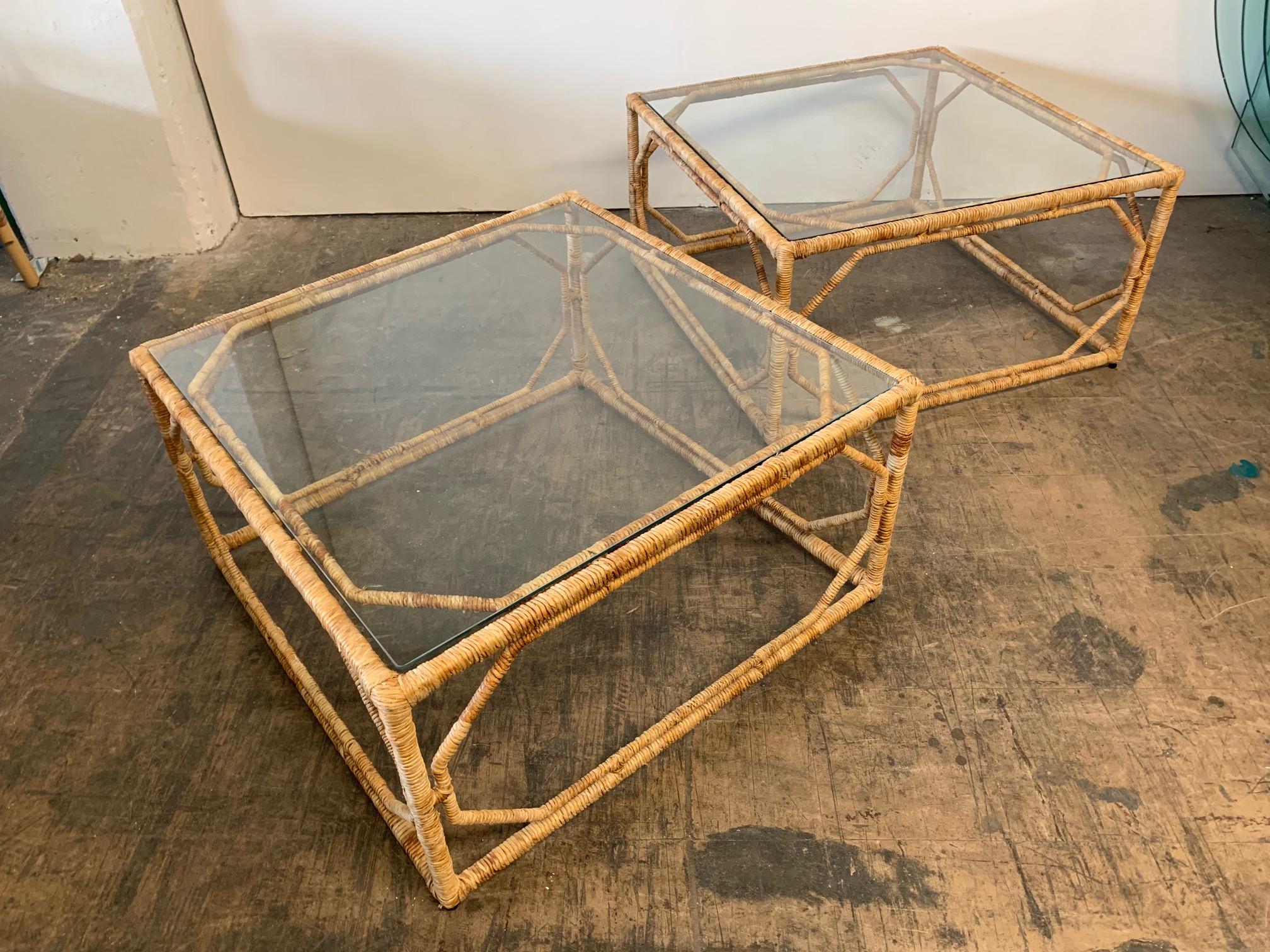 Rattan wrapped side tables feature solid iron construction and glass tops. Very good condition with minor imperfections consistent with age.