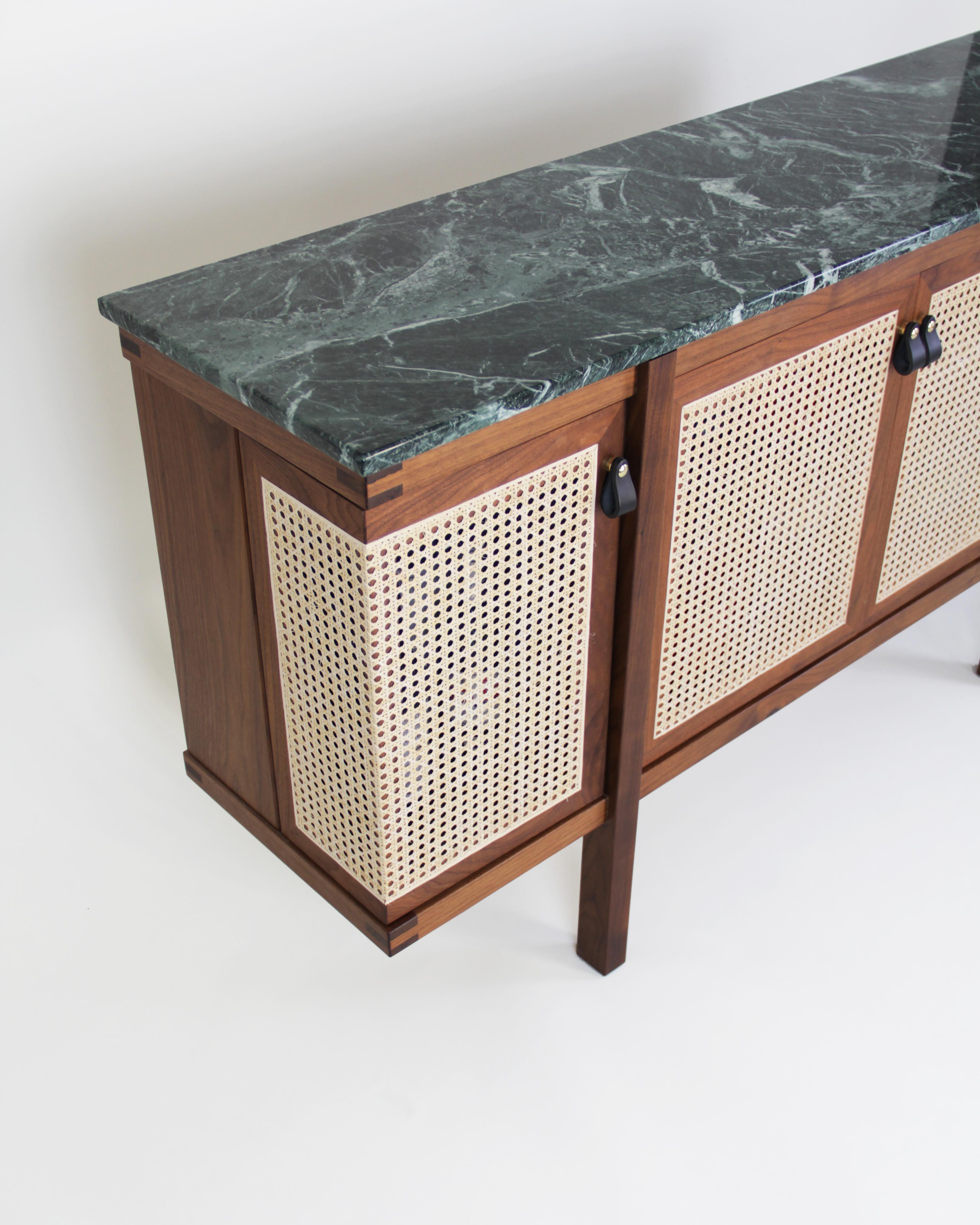 This vernacular Mid-Century Modern inspired console is superbly detailed as well as practical. Handcrafted from three separately fabricated boxes with doors that are inserted into the frame, it serves as a cabinet bar and credenza, offering ample