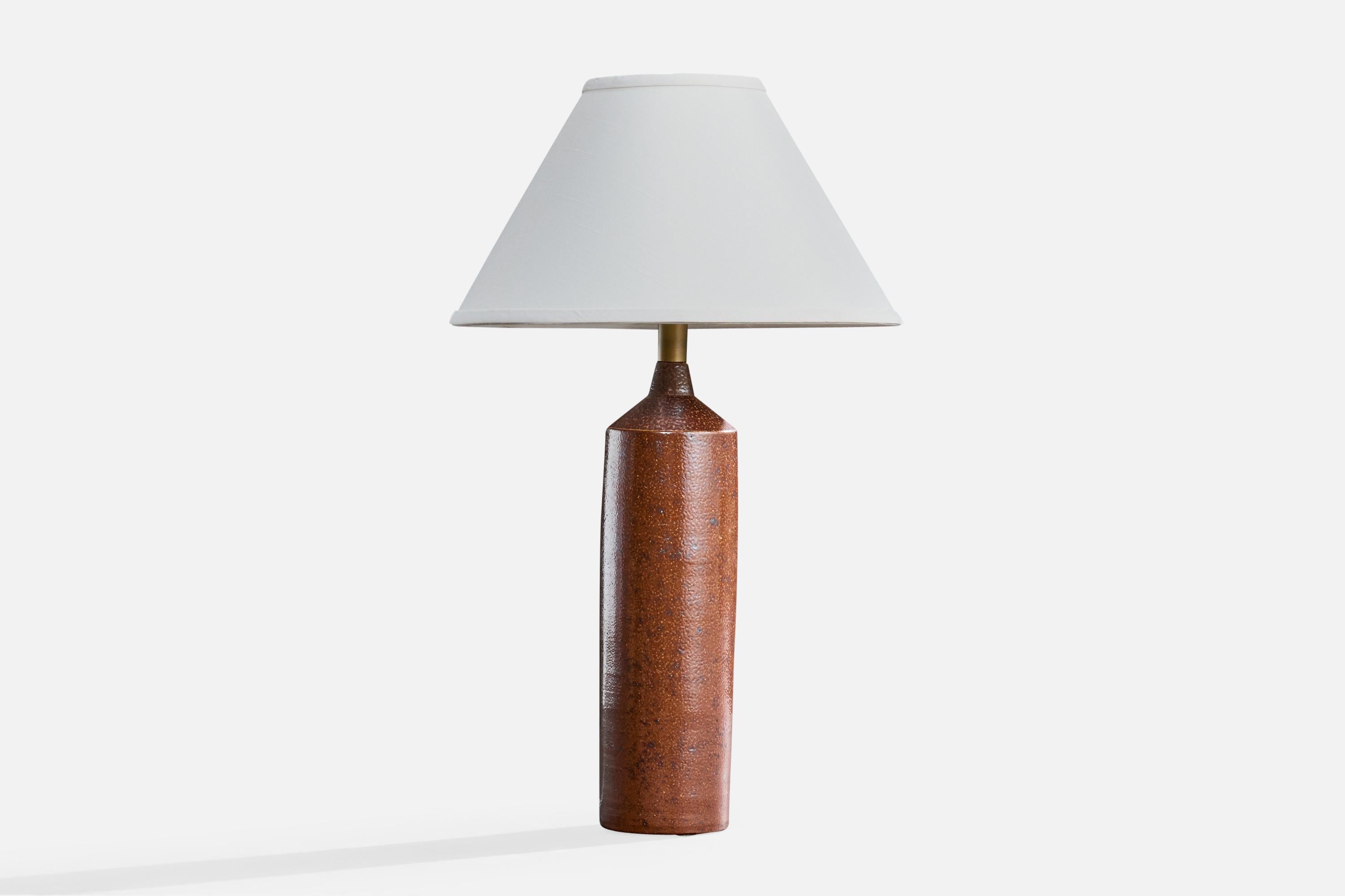A brown-glazed ceramic table lamp produced by Raus Keramik, Sweden, c. 1940s.

Socket likely replaced at some point in history.

Overall Dimensions (inches): 21.25