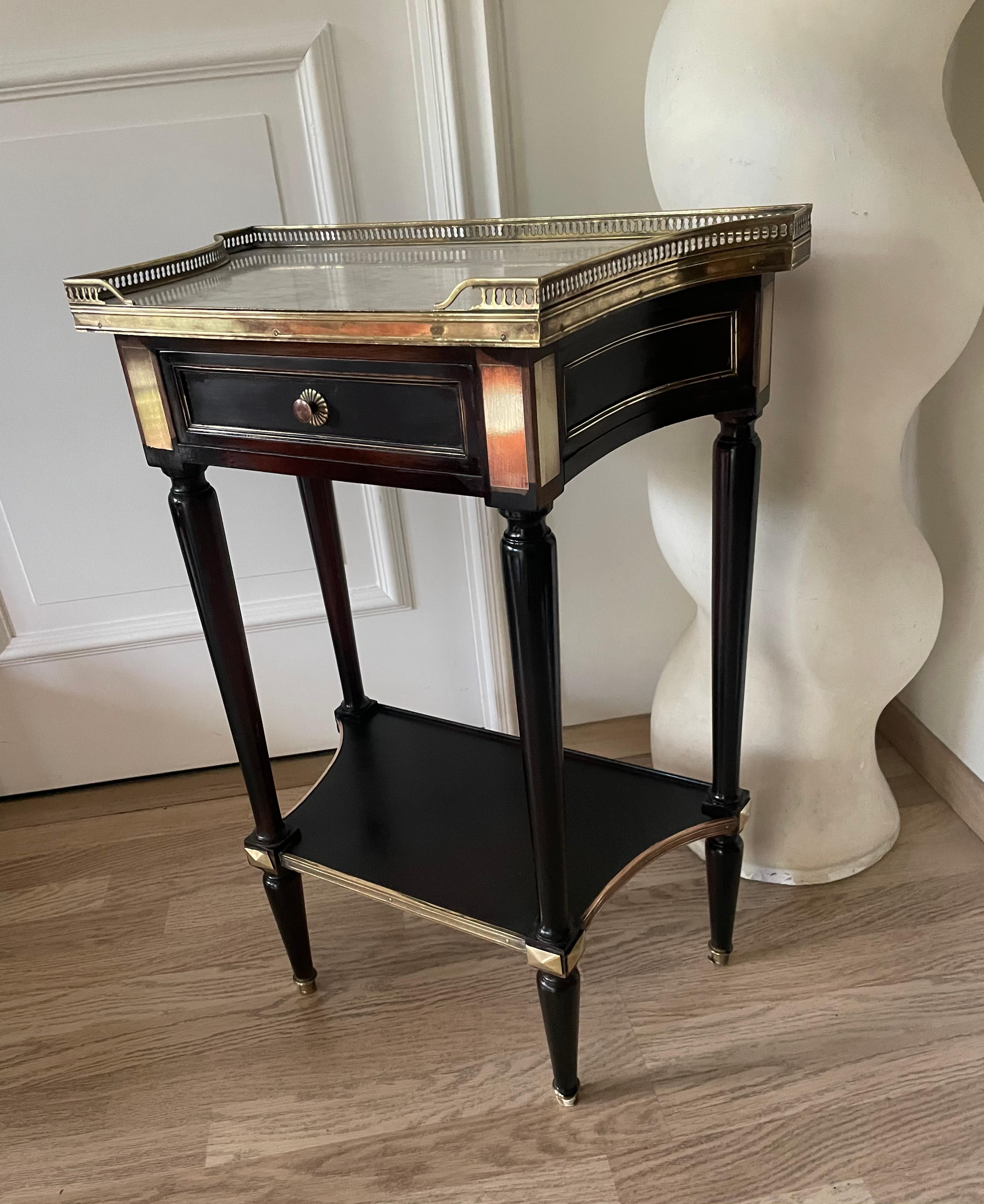 Charming two-tier console table with a lot of brass accents.
Carrara marble top surrounded by a fine 