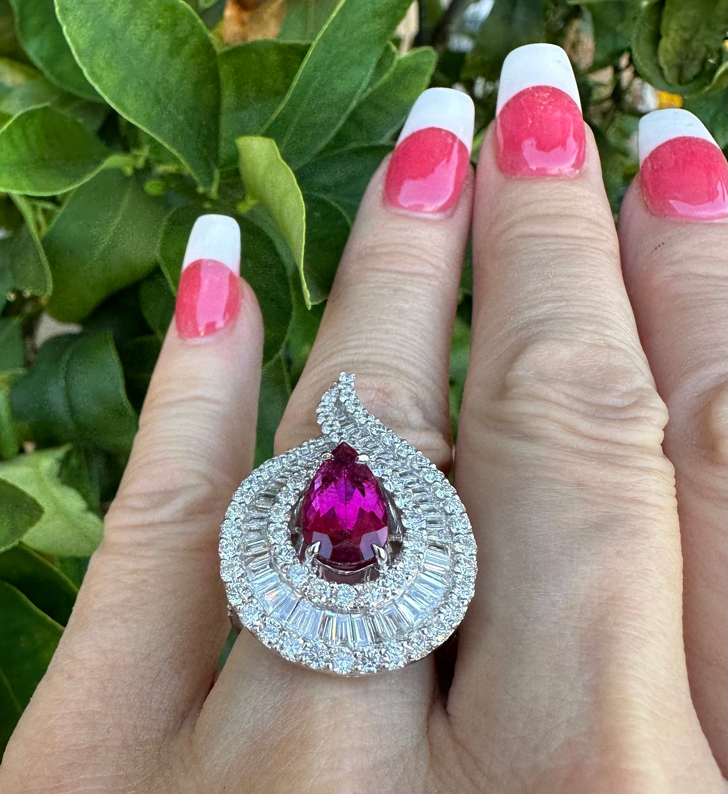 Ravishing and stately, 18 karat white gold 10.58 carat diamond cocktail ring features a large tear drop pear shaped design with an open center that has a vivid pinkish red natural no heat Brazilian rubellite in the center.  This is a very showy and