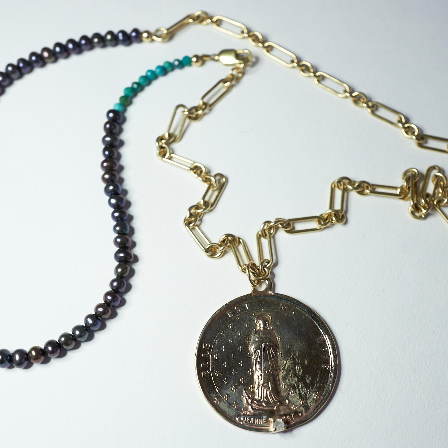 Raw Diamond Black Pearl Medal Coin Pendant Long Chain Necklace Turquoise Bead J Dauphin

Exclusive piece with a Round Medal Coin with French Saint Jeanne Le Mat in Bronze and a Raw Diamond set in a Gold prong hanging on a Black Pearl Turquoise gold