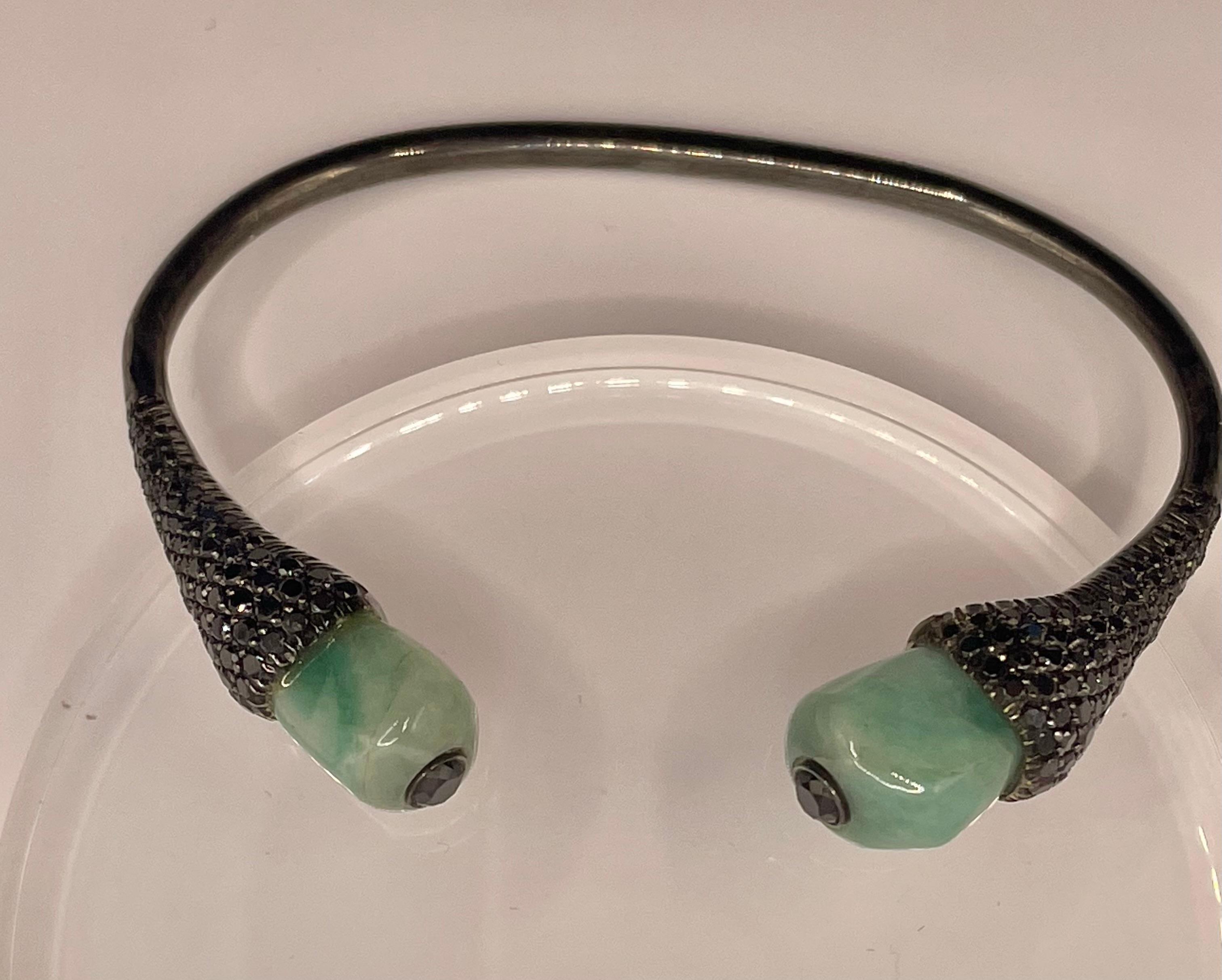 Row emeralds and black diamonds (3.95 ct) bracelet set in blackened silver and 18k gold covered in black rhodium. Open cuff bangle  : slide it  on the wrist sideways.