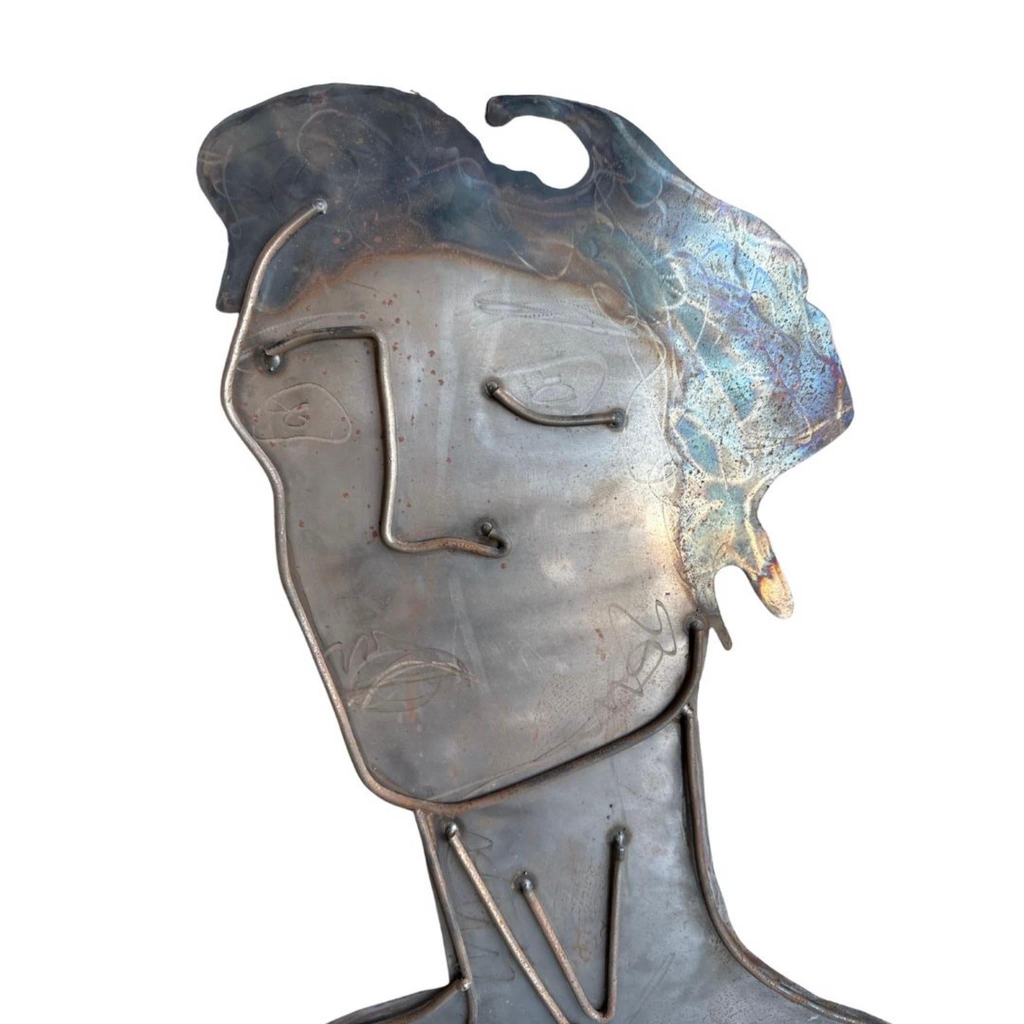 Raw sheet metal figurative abstract portrait wall hanging.


